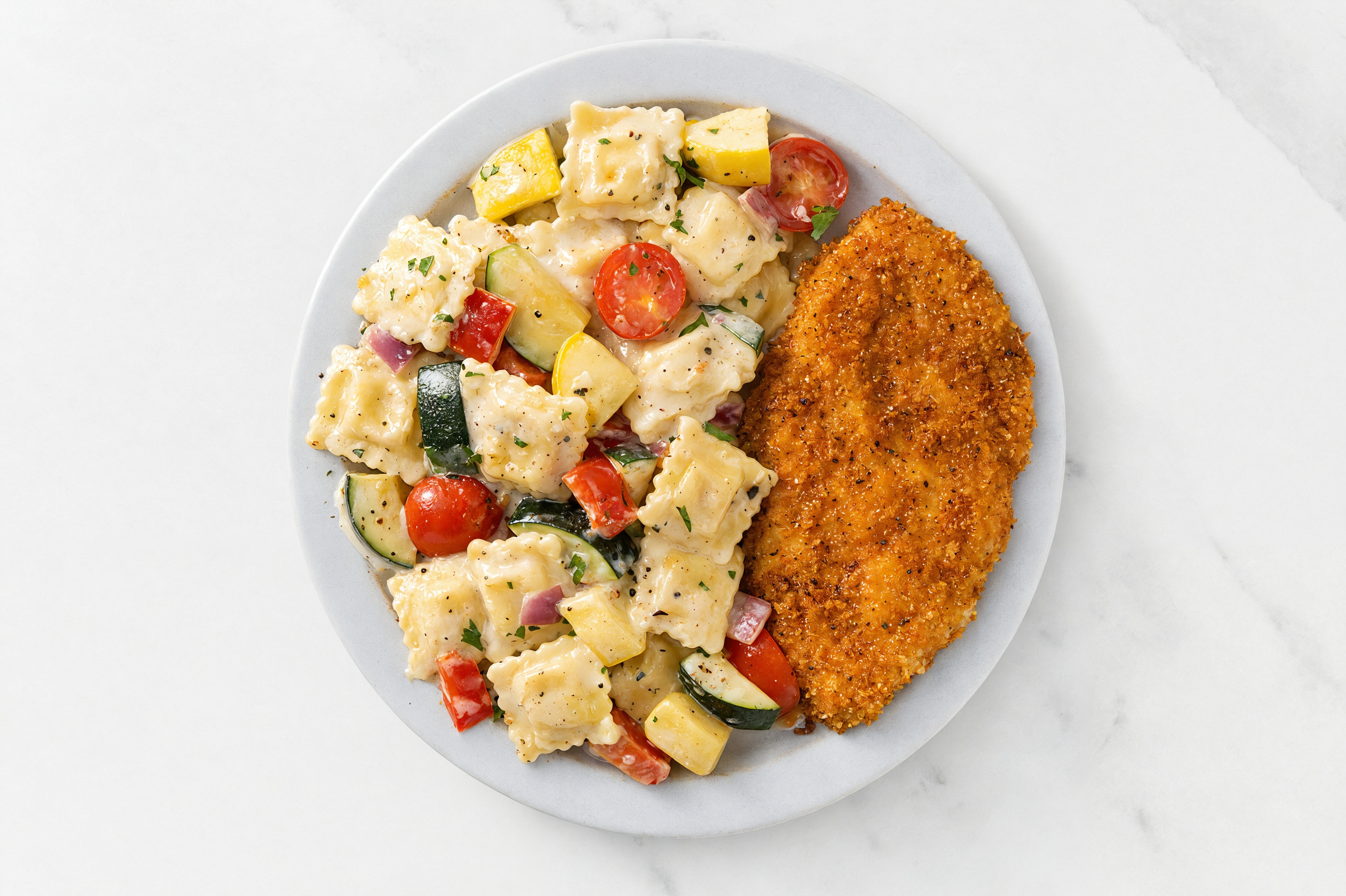 Crispy Hot Honey Chicken over Alfredo Ravioli with Mixed Veggies