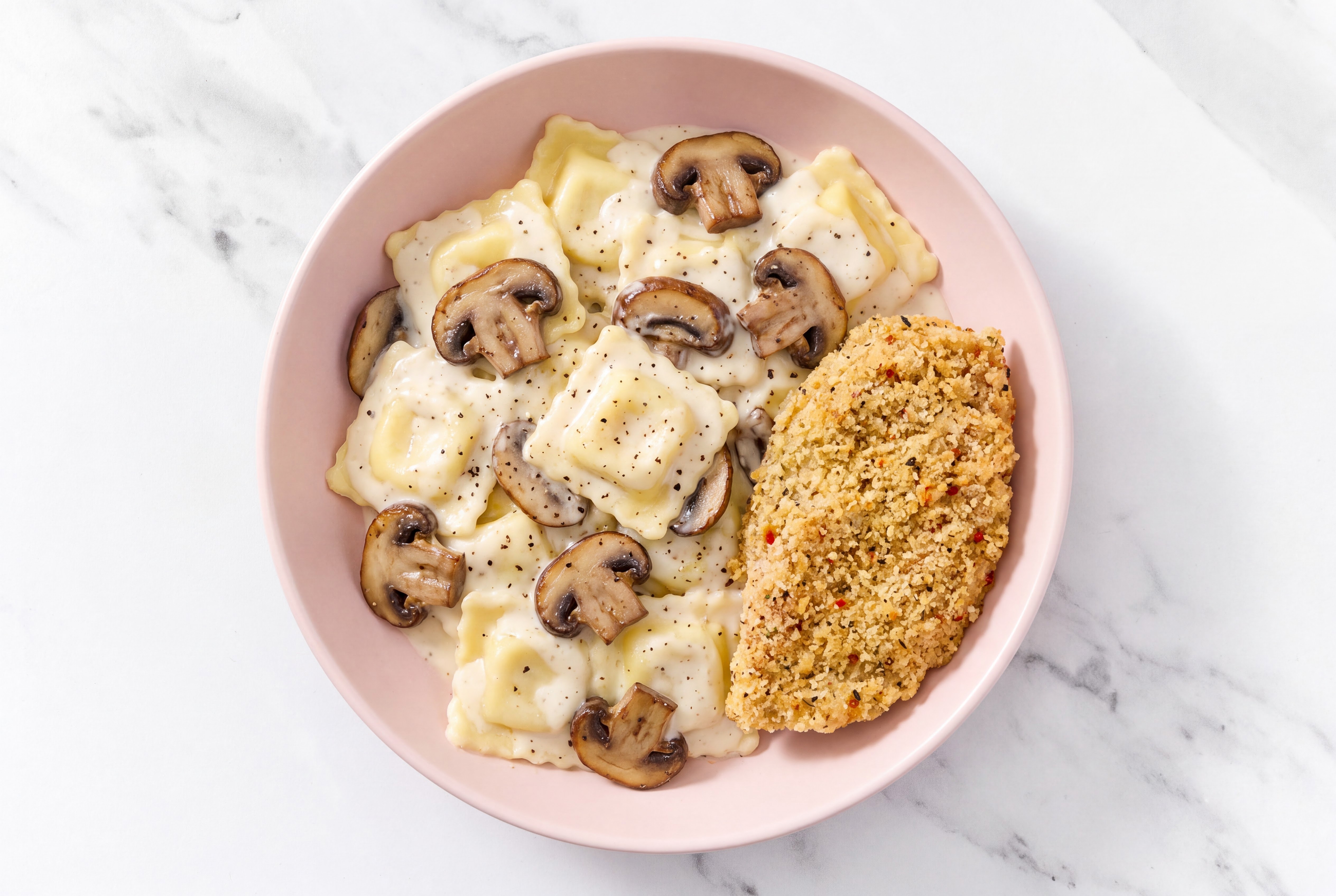 Crispy Garlic Chicken over Alfredo Ravioli with Baby Bella Mushrooms