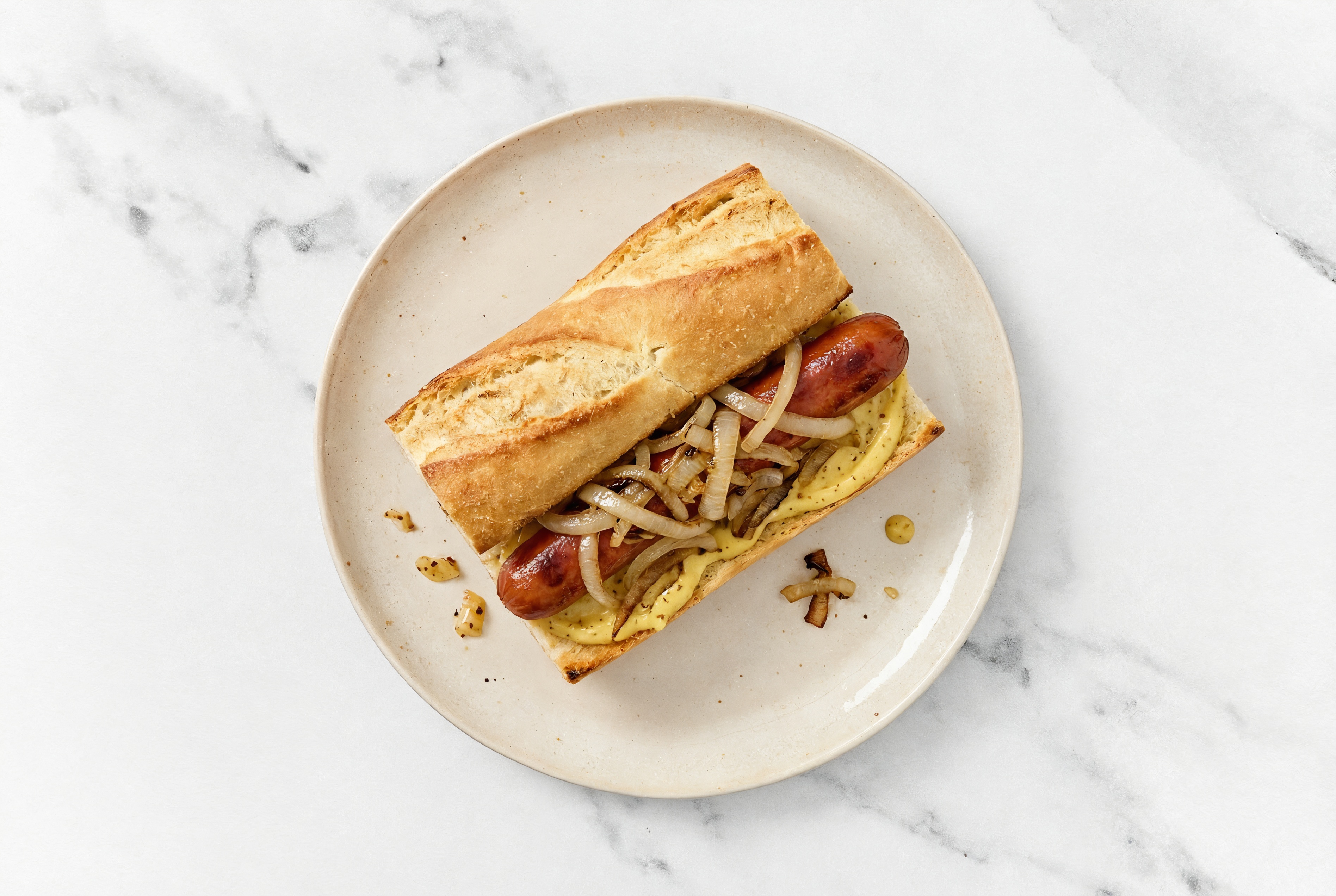 Carmelized Onion Beef Hot Dog with Honey Mustard on Baguette