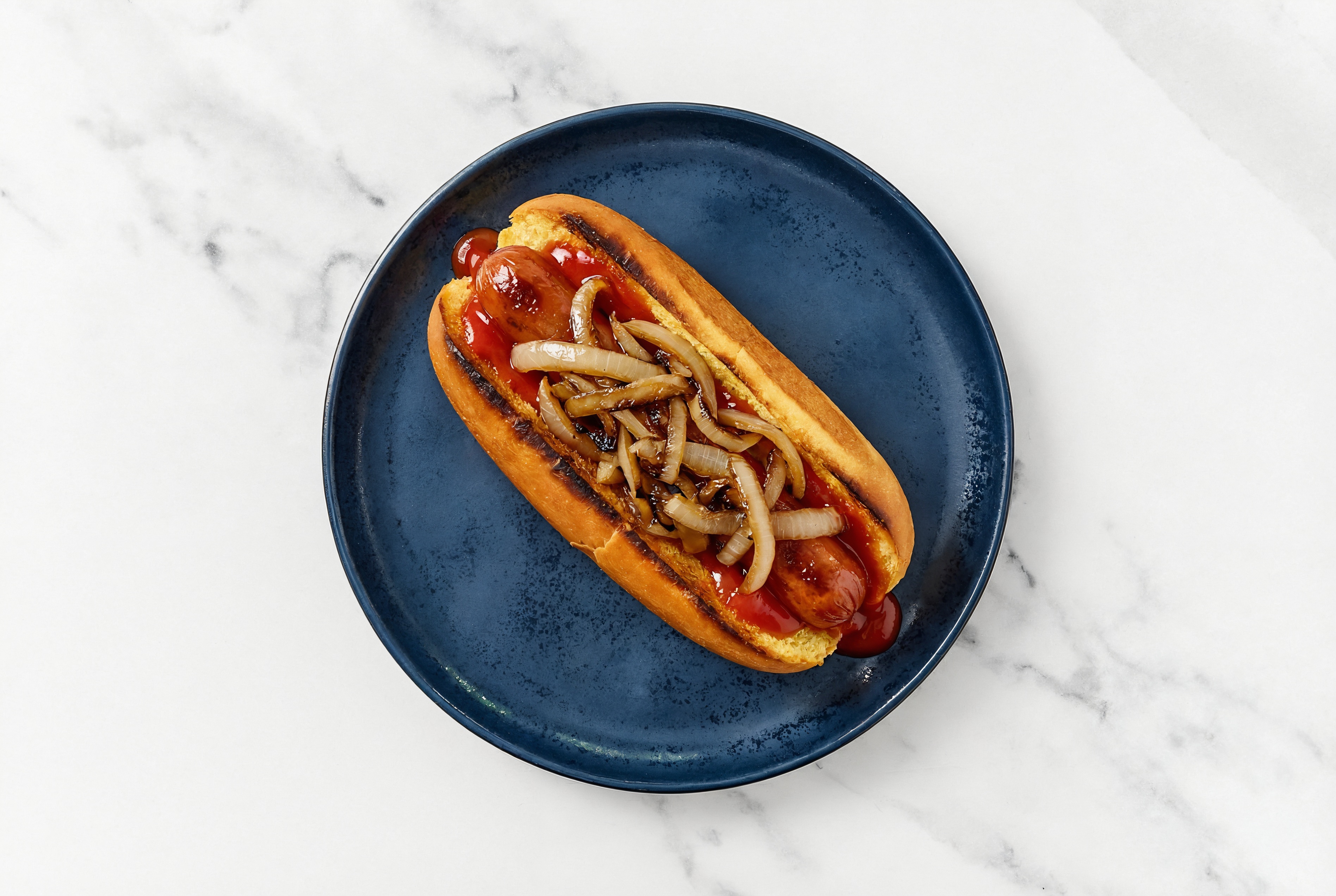 Carmelized Onion Beef Hot Dog with Ketchup on Brioche