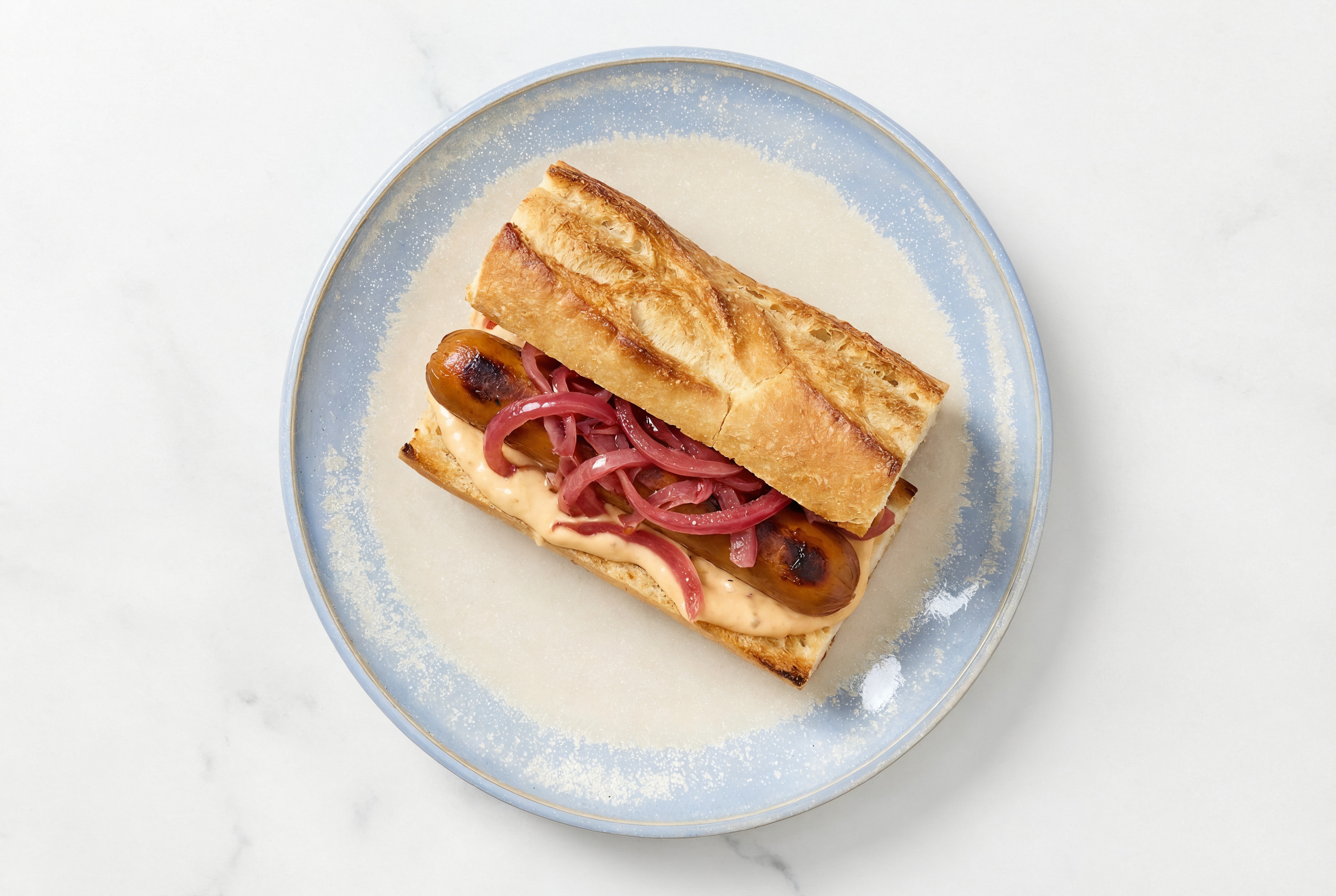 Pickled Red Onion Smart Dog with Awesome Sauce on Baguette