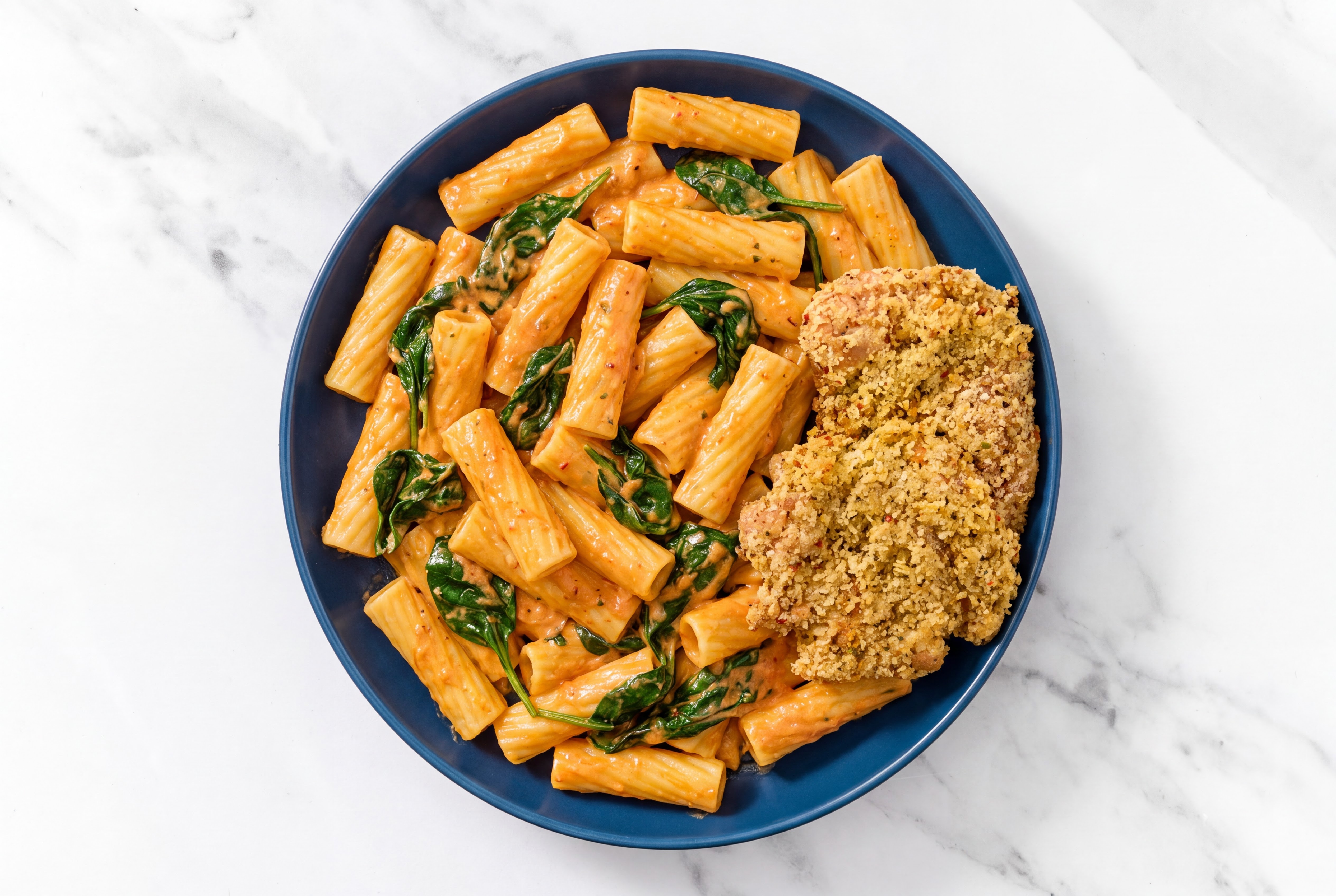 Crispy Garlic Chicken over Creamy Vodka Rigatoni with Baby Spinach
