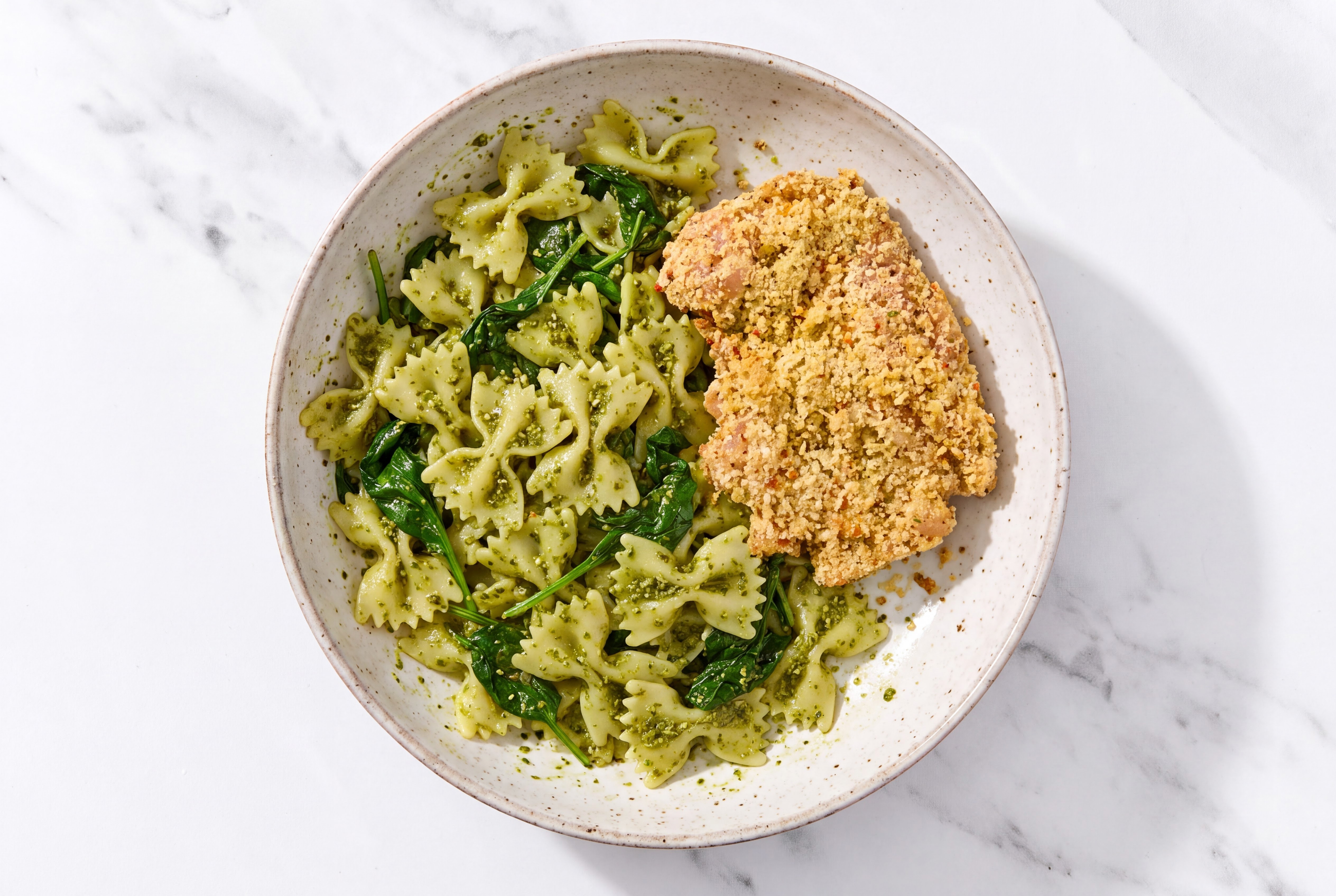 Crispy Garlic Chicken over Pesto Farfalle with Baby Spinach
