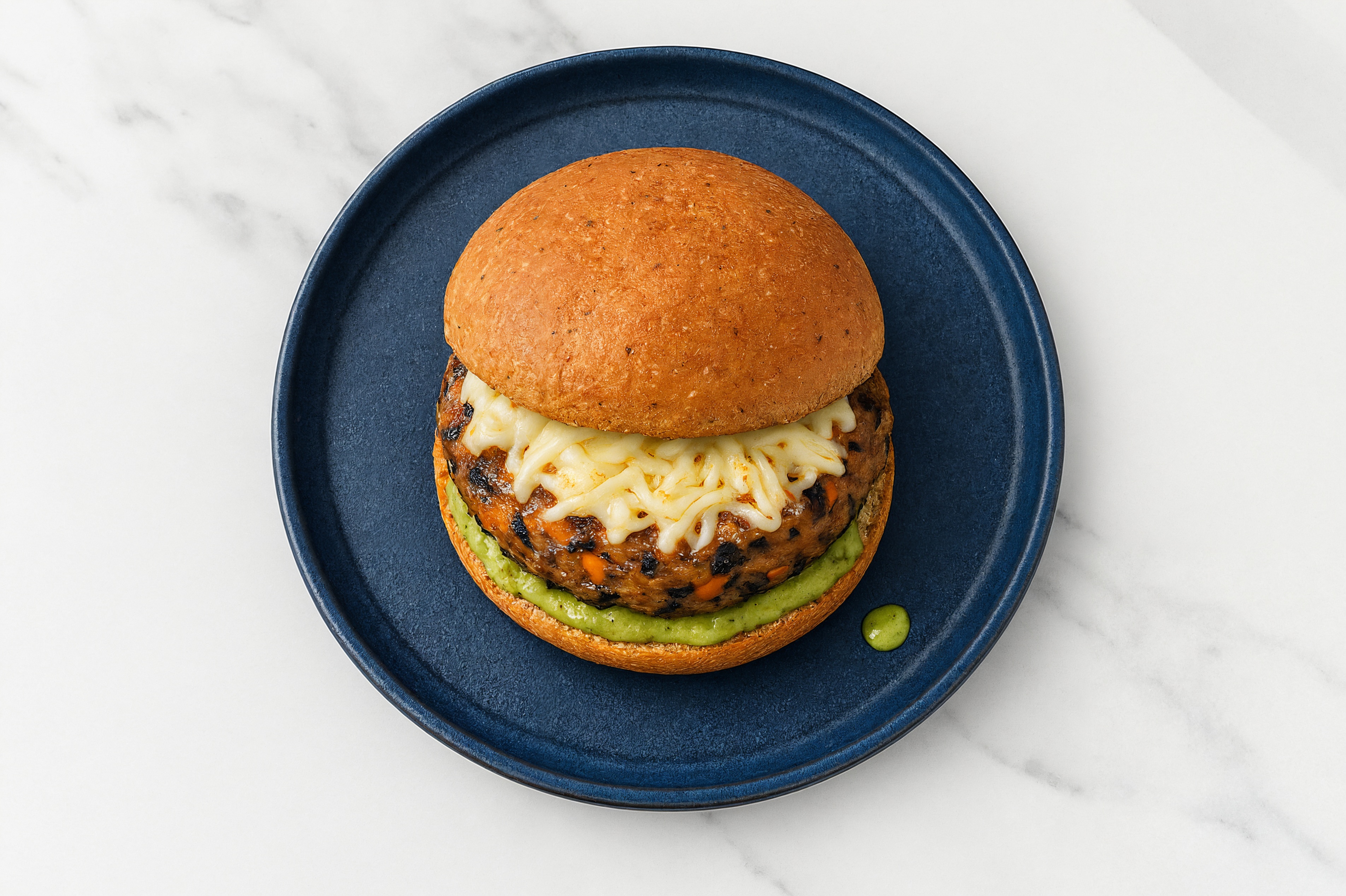 Black Patties with Vegan Mozzarella + Pesto Aioli on Whole Grain Buns