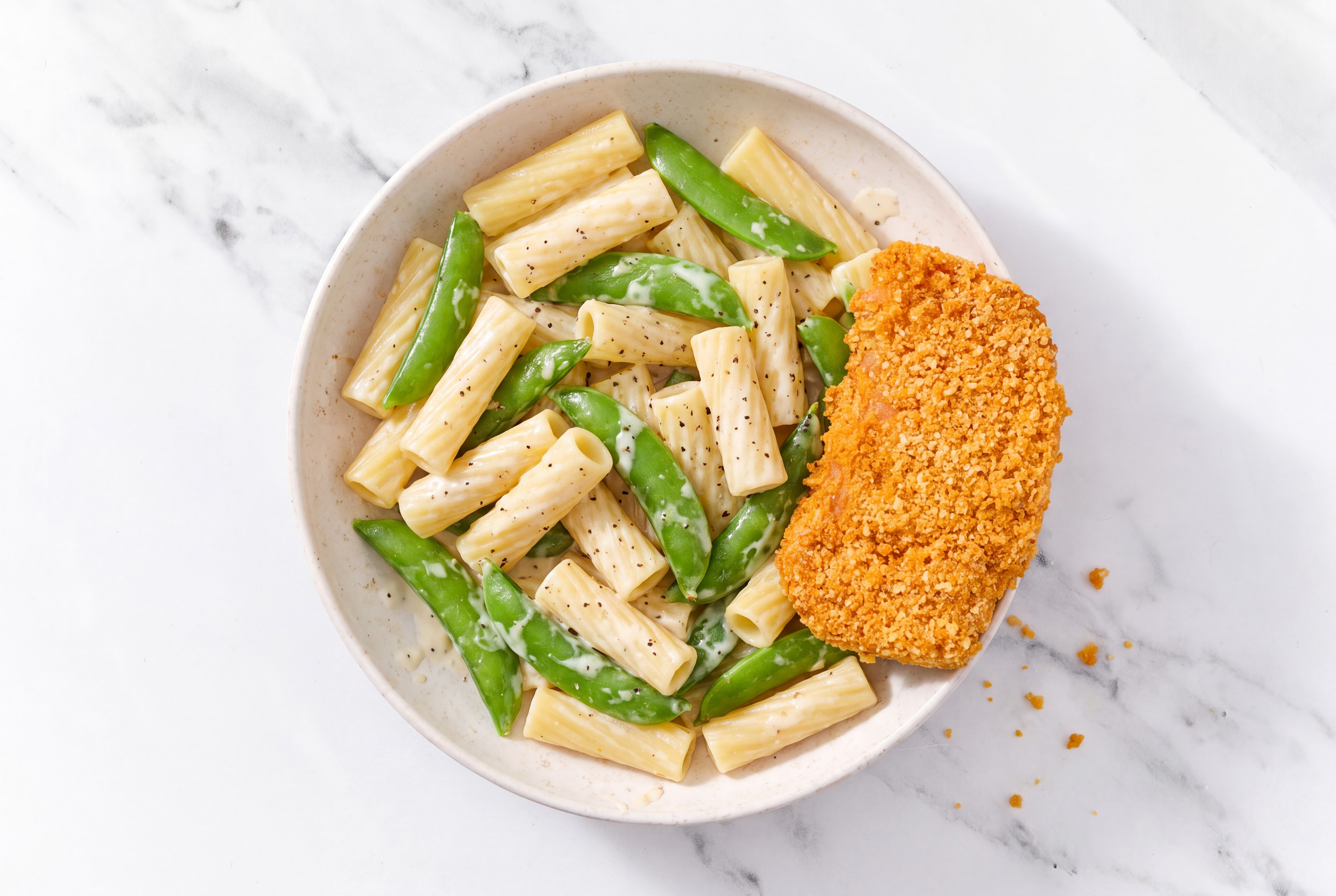 Crispy Hot Honey Chicken over Alfredo Rigatoni with Snap Peas