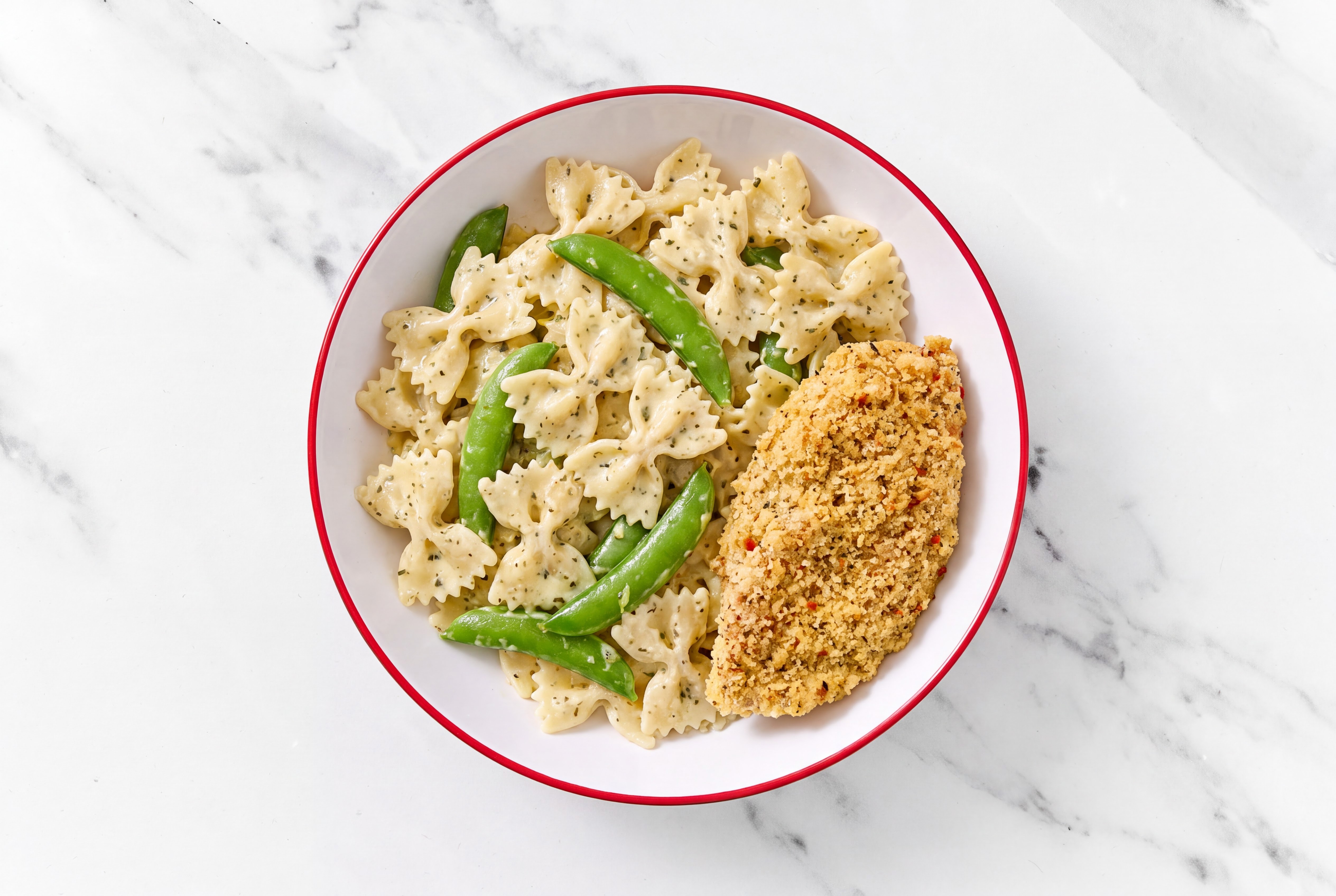 Crispy Garlic Chicken over Creamy Farfalle with Snap Peas