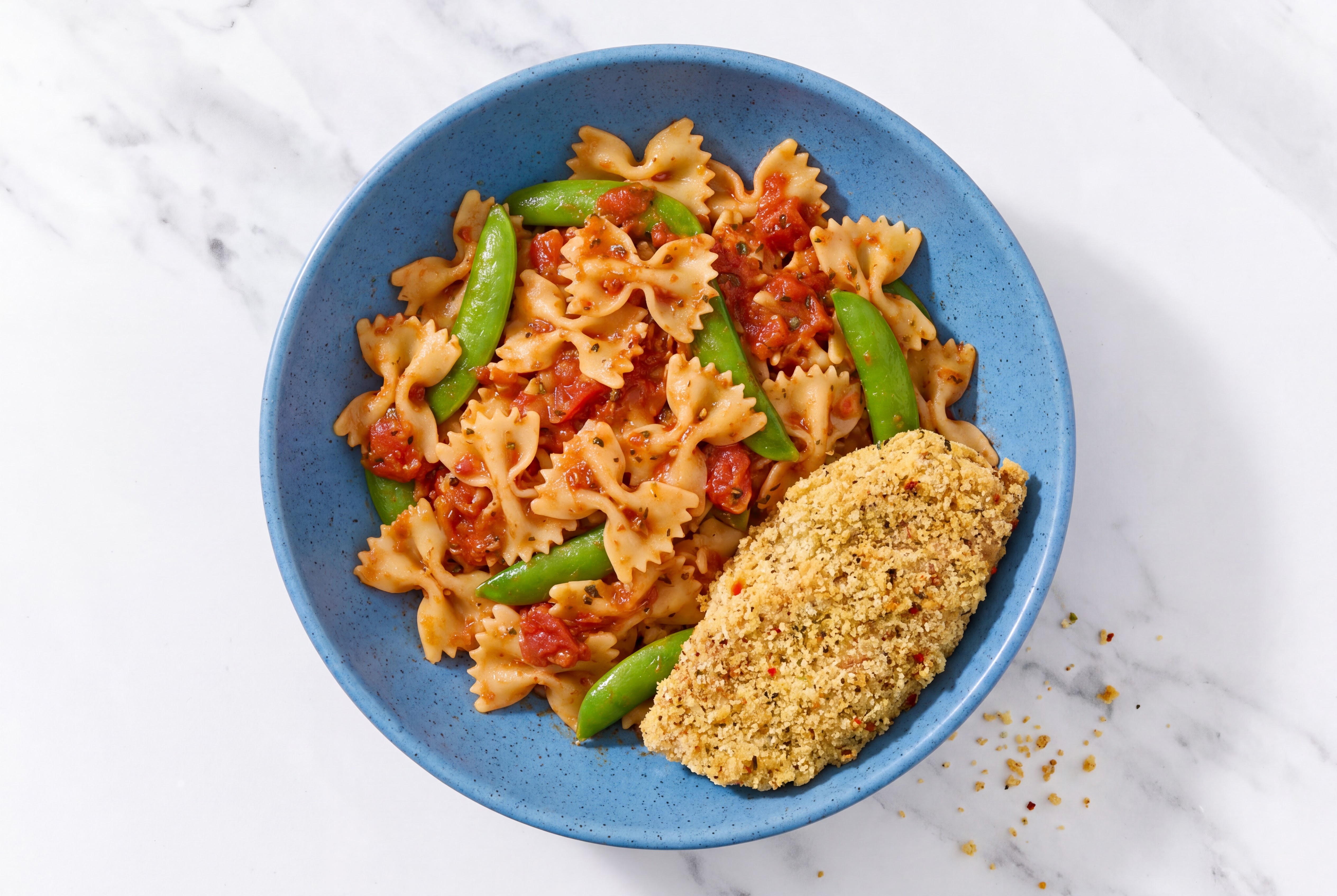 Crispy Garlic Chicken over Marinara Farfalle with Snap Peas