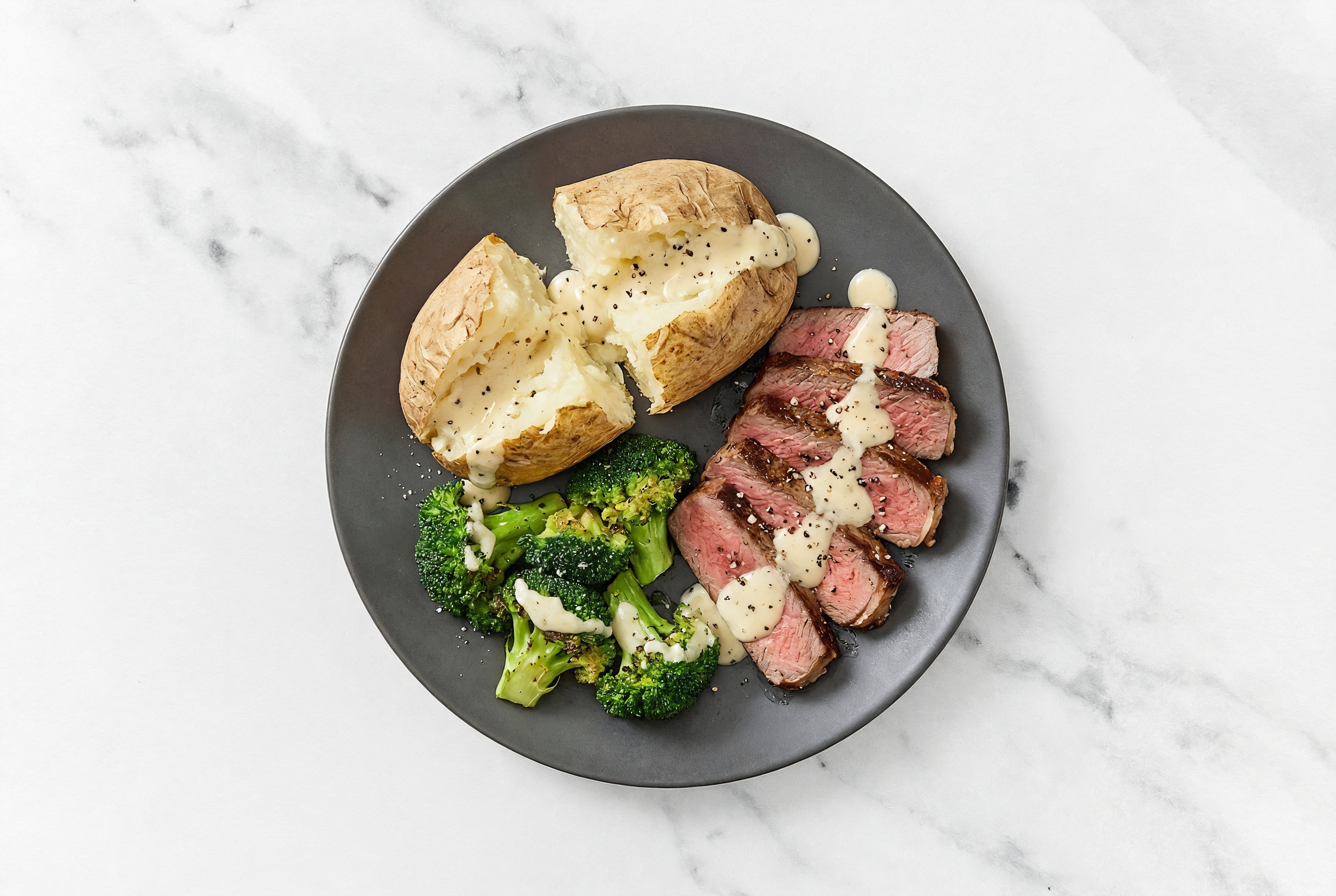 Creamy Asiago + Peppercorn Ribeye with a Baked Potato with Broccoli Bunches