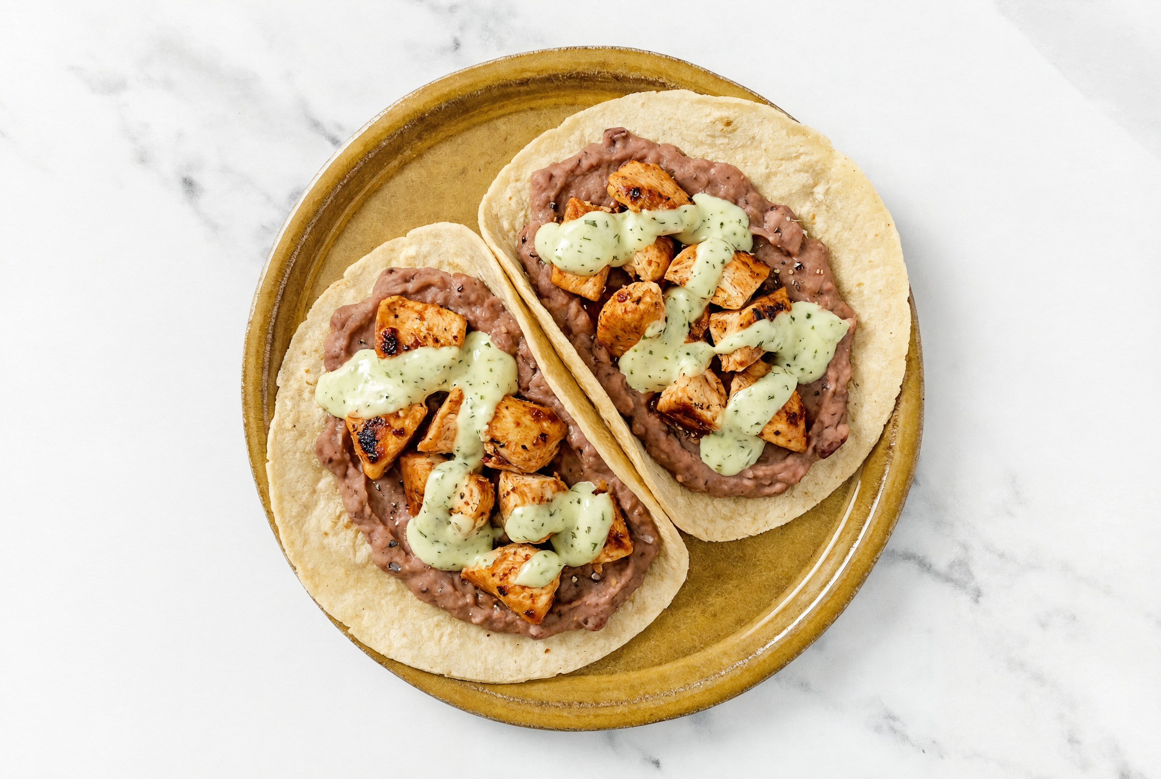 Chipotle Chicken Tacos with Jalapeño Crema & Refried Red Beans