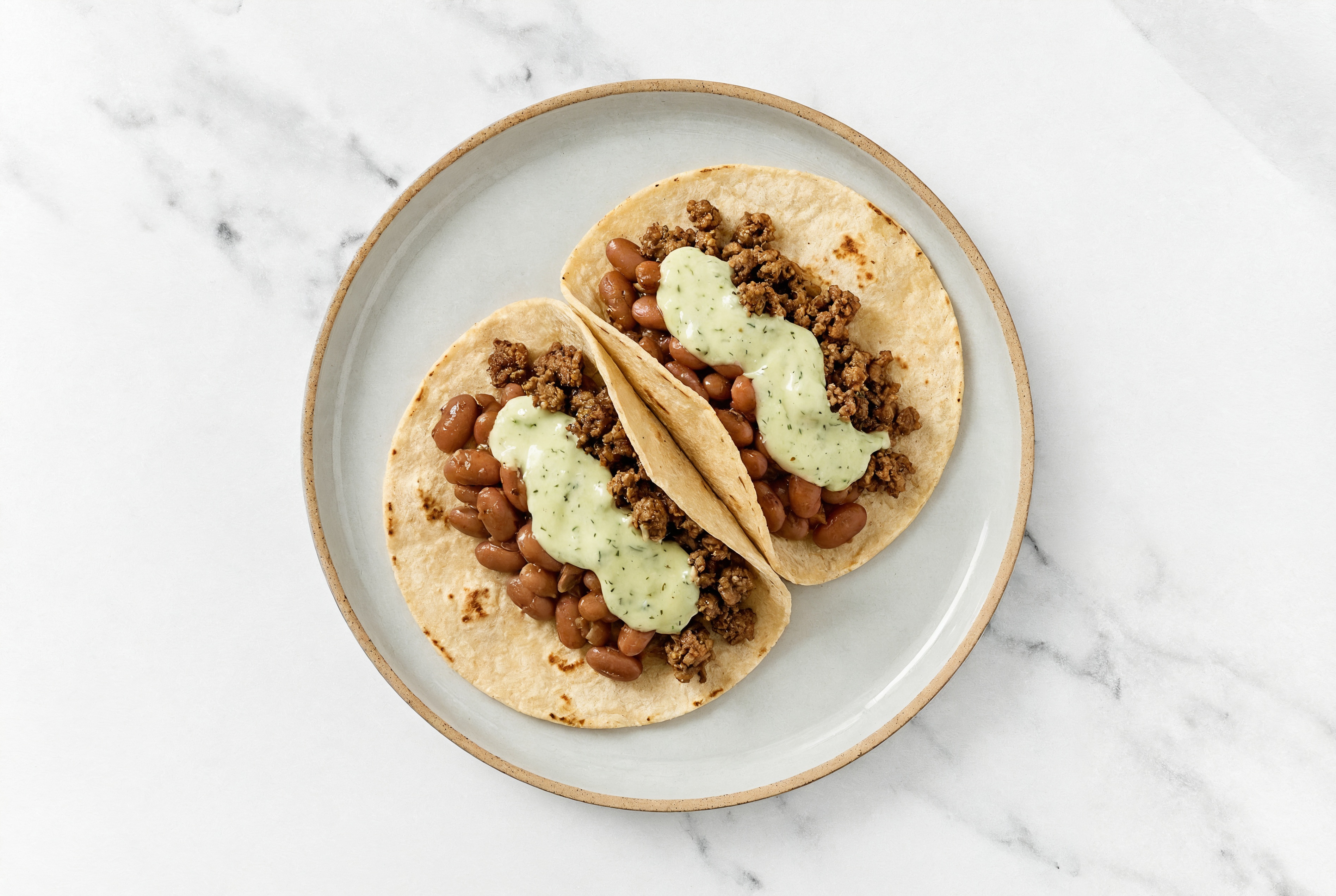 Mexican-Style Ground Beef Tacos with Jalapeño Crema & Pinto Beans