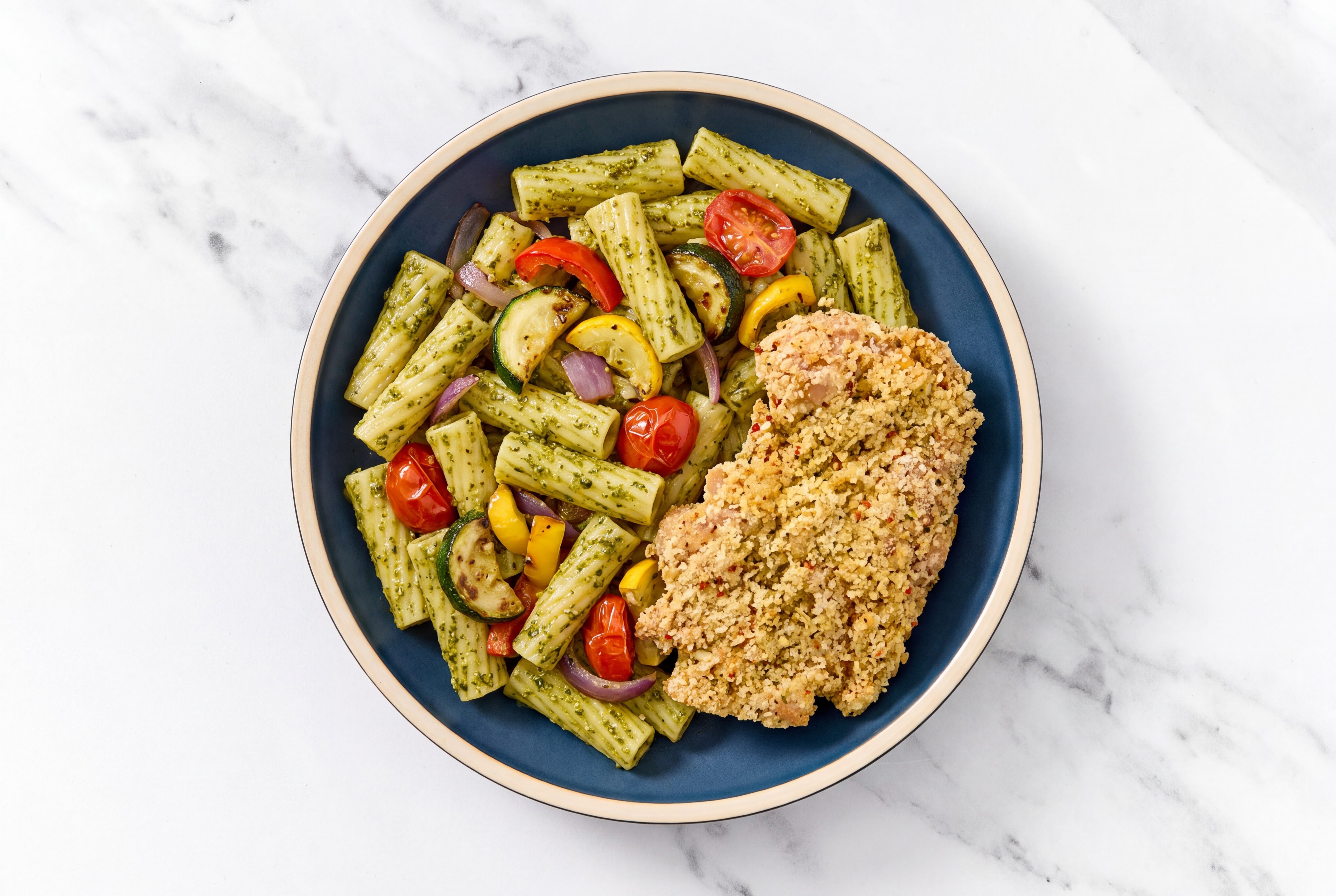 Crispy Garlic Chicken over Pesto Rigatoni with Mixed Veggies