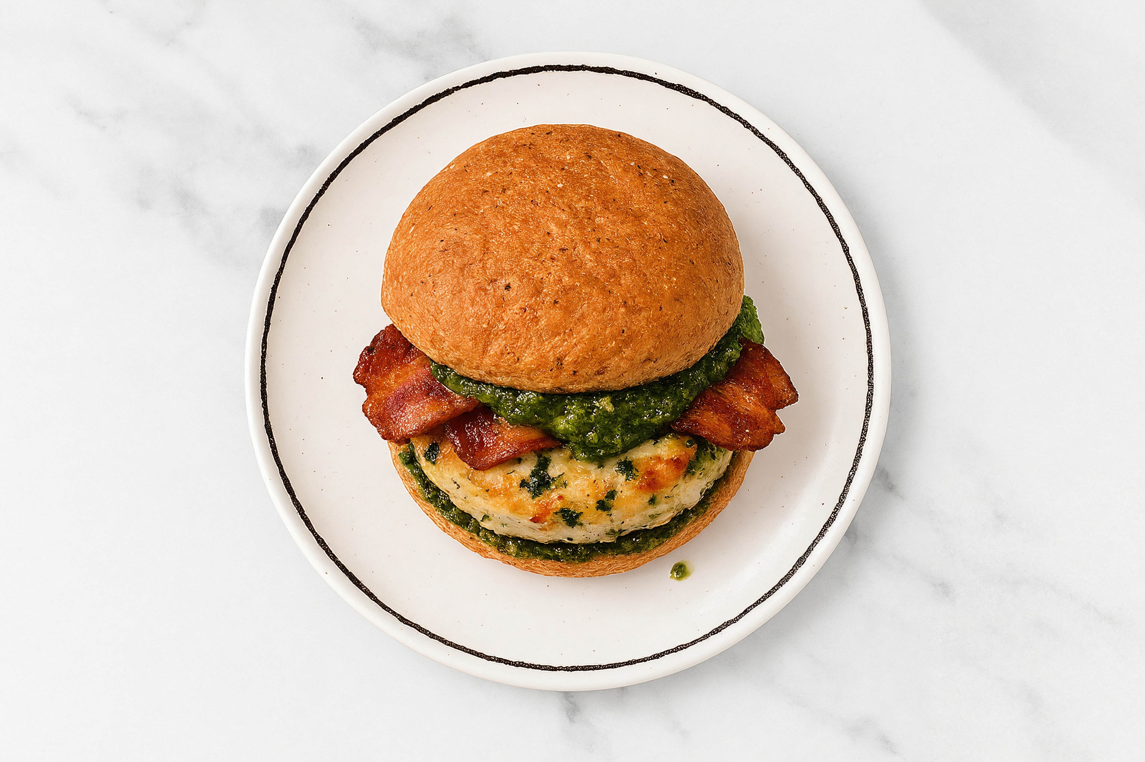 Garlic Chicken Burger on Sprouted Grain with Spinach Pesto & Applewood Smoked Pork Bacon