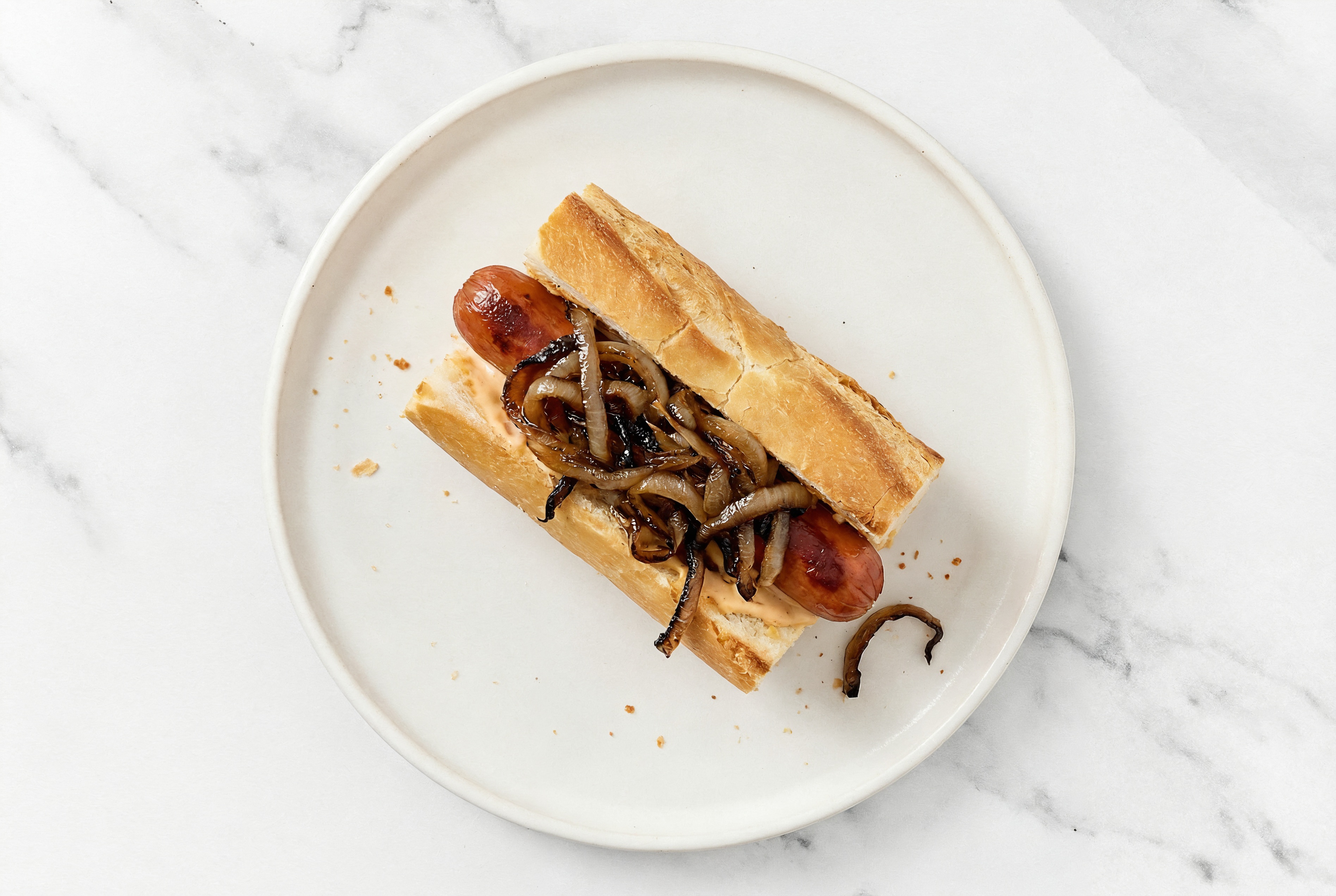Carmelized Onion Beef Hot Dog with Awesome Sauce on Baguette