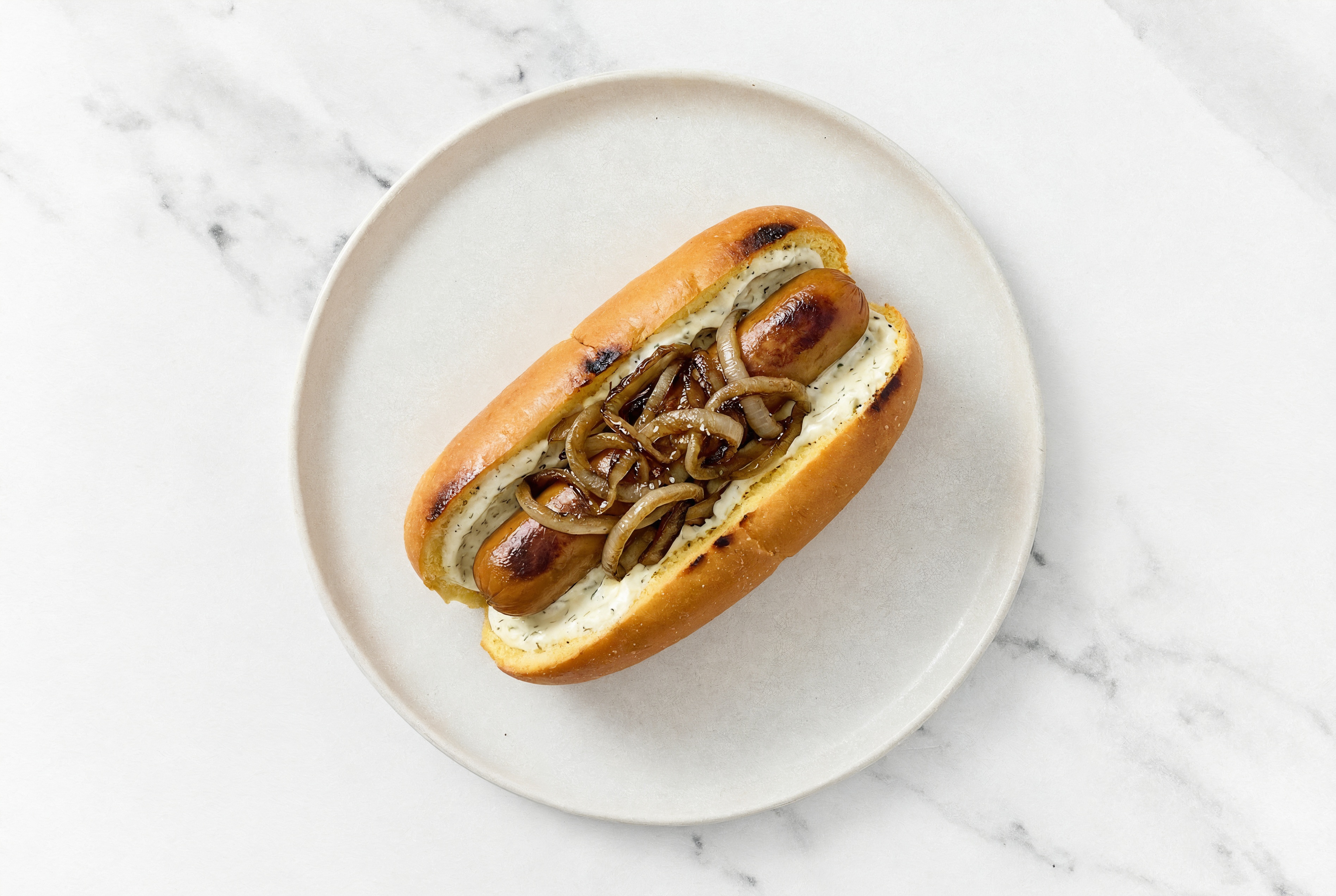 Carmelized Onion Smart Dog with Garlic Sauce on Brioche