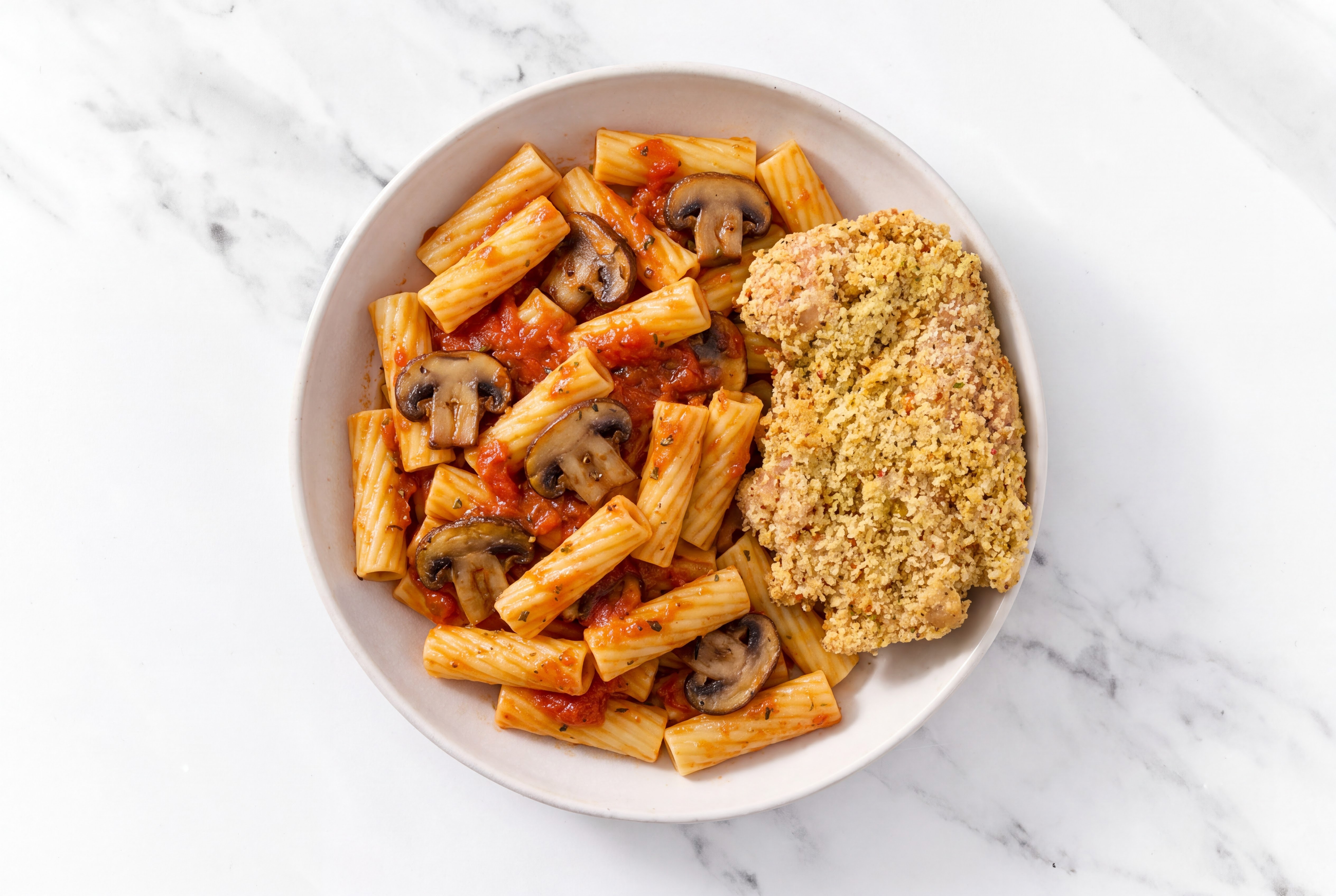 Crispy Garlic Chicken over Marinara Rigatoni with Baby Bella Mushrooms