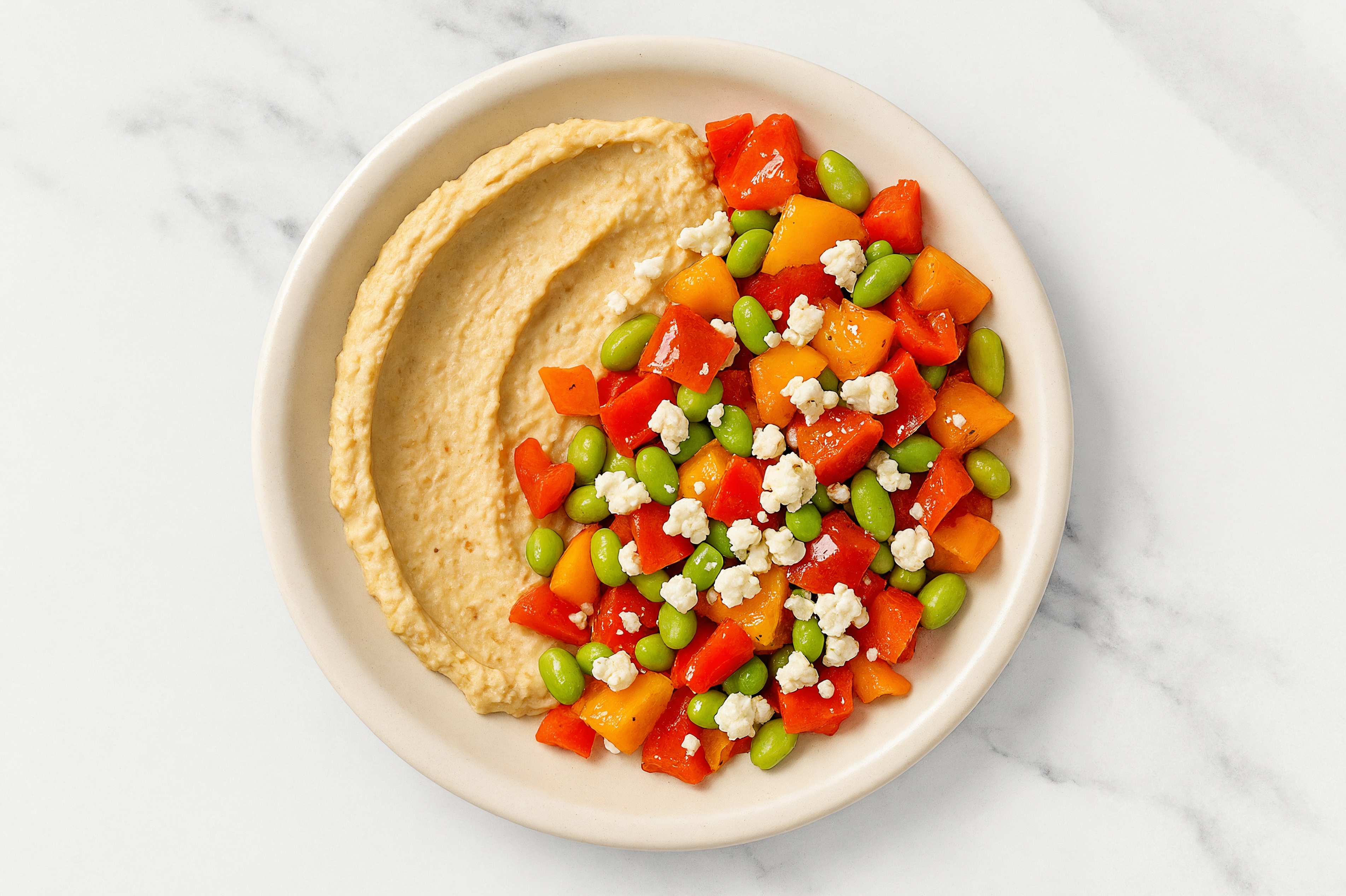 Crumbled Chevre Sweet Pepper Edamame Bowl over Onion Hummus