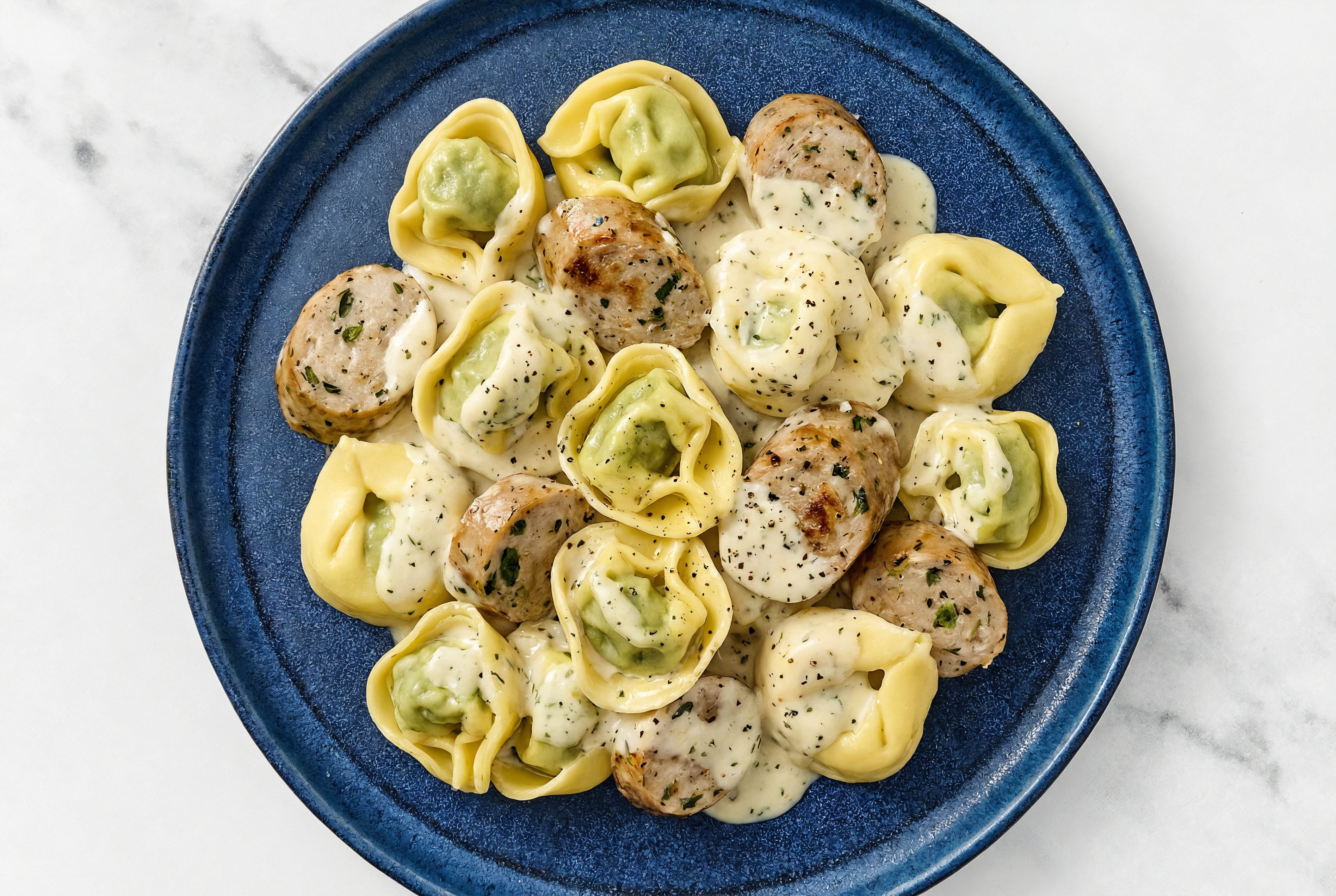 Herb Cream Tortellini with Garlicky Chicken Sausage