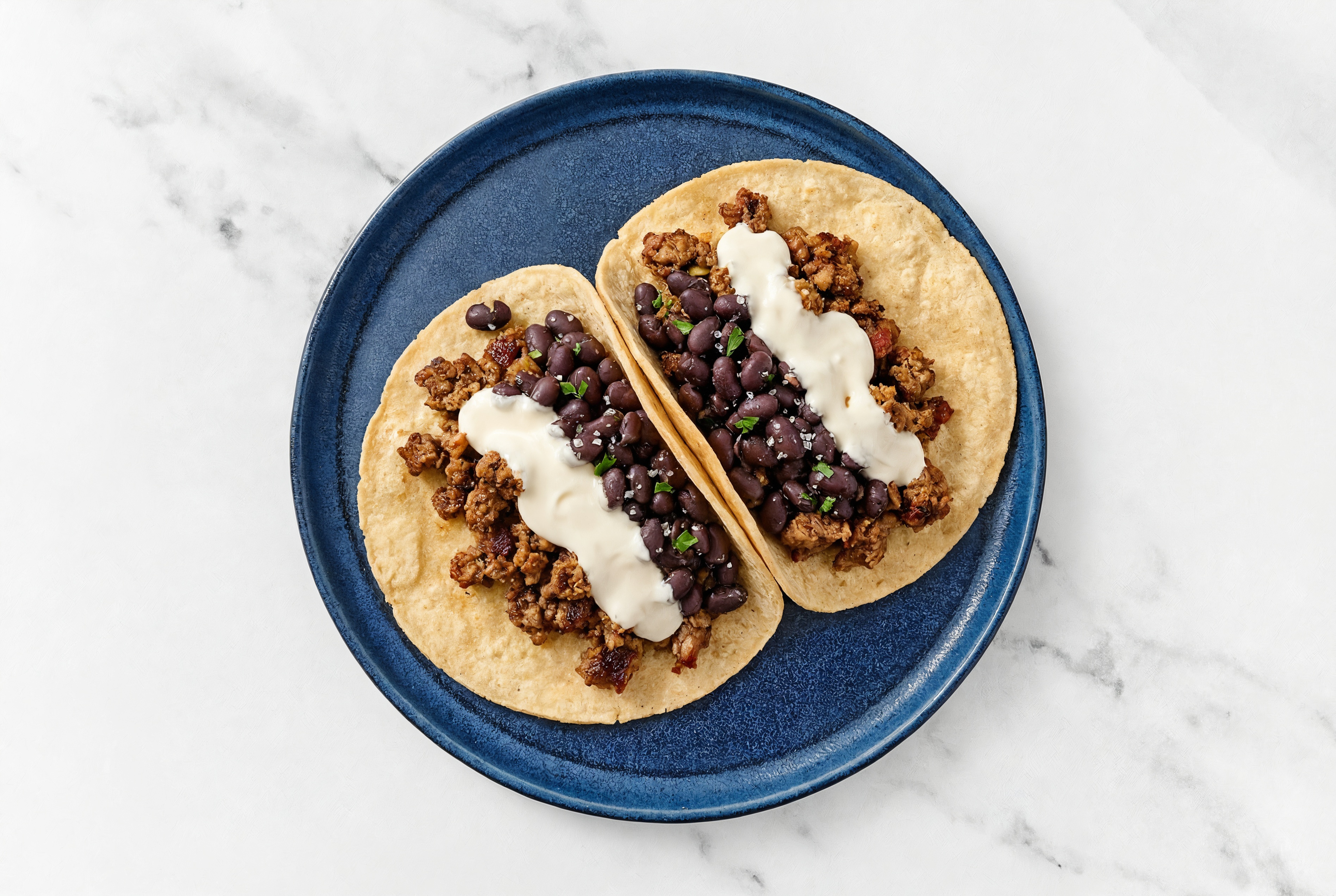 Mexican-Style Ground Beef Tacos with Crema & Spiced Beans