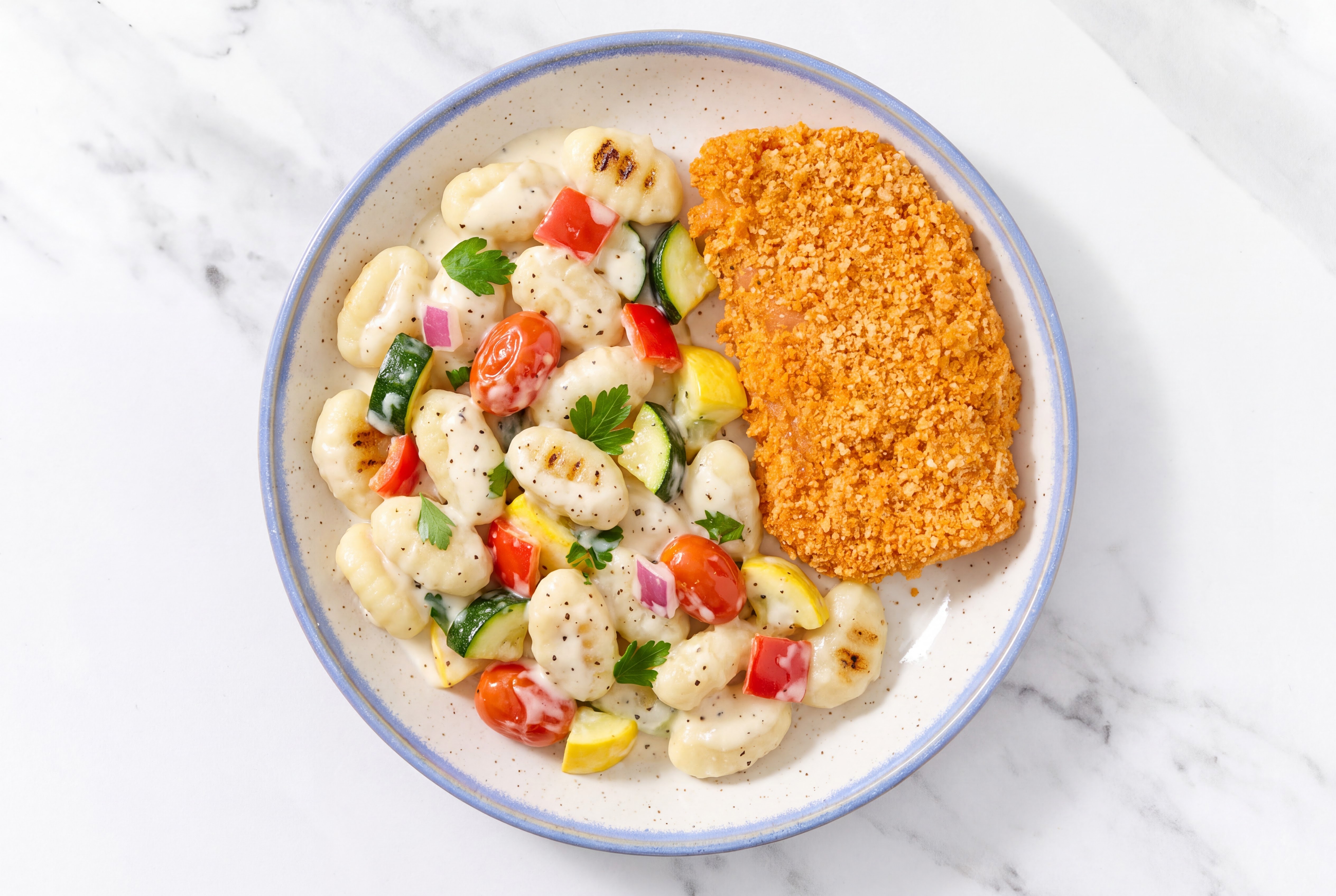 Crispy Hot Honey Chicken over Alfredo Gnocchi with Mixed Veggies