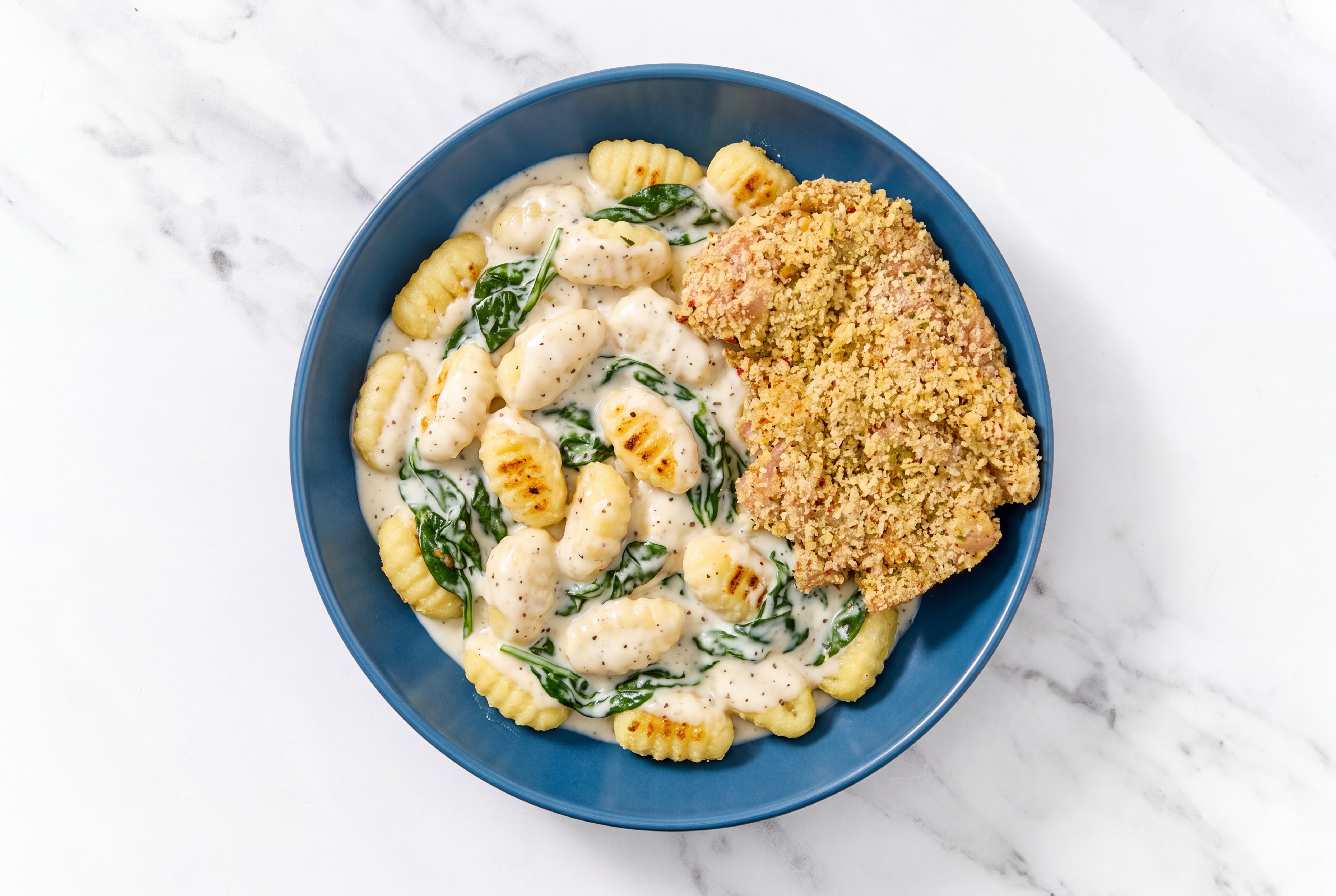 Crispy Garlic Chicken over Alfredo Gnocchi with Baby Spinach