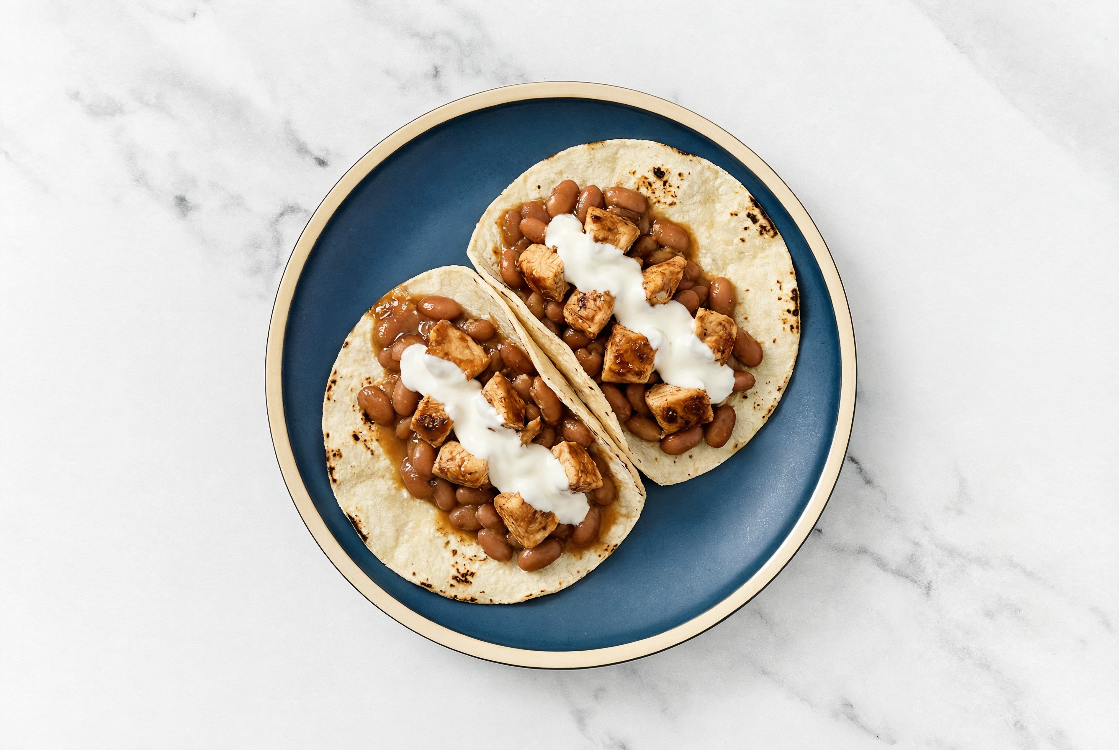 Hearty Chipotle Chicken Tacos with Crema & Pinto Beans