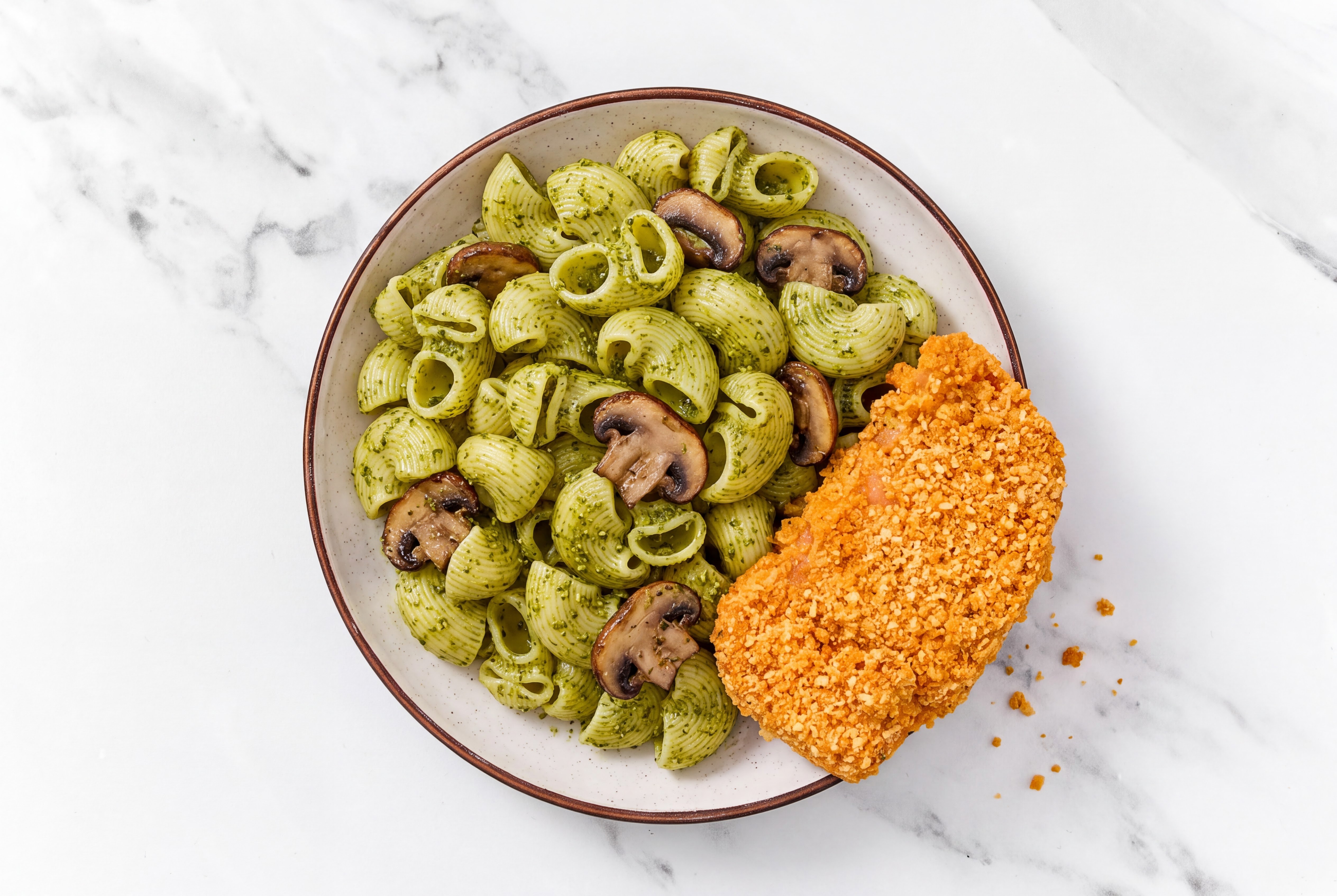 Crispy Hot Honey Chicken over Pesto Chiocciole Pasta with Baby Bella Mushrooms