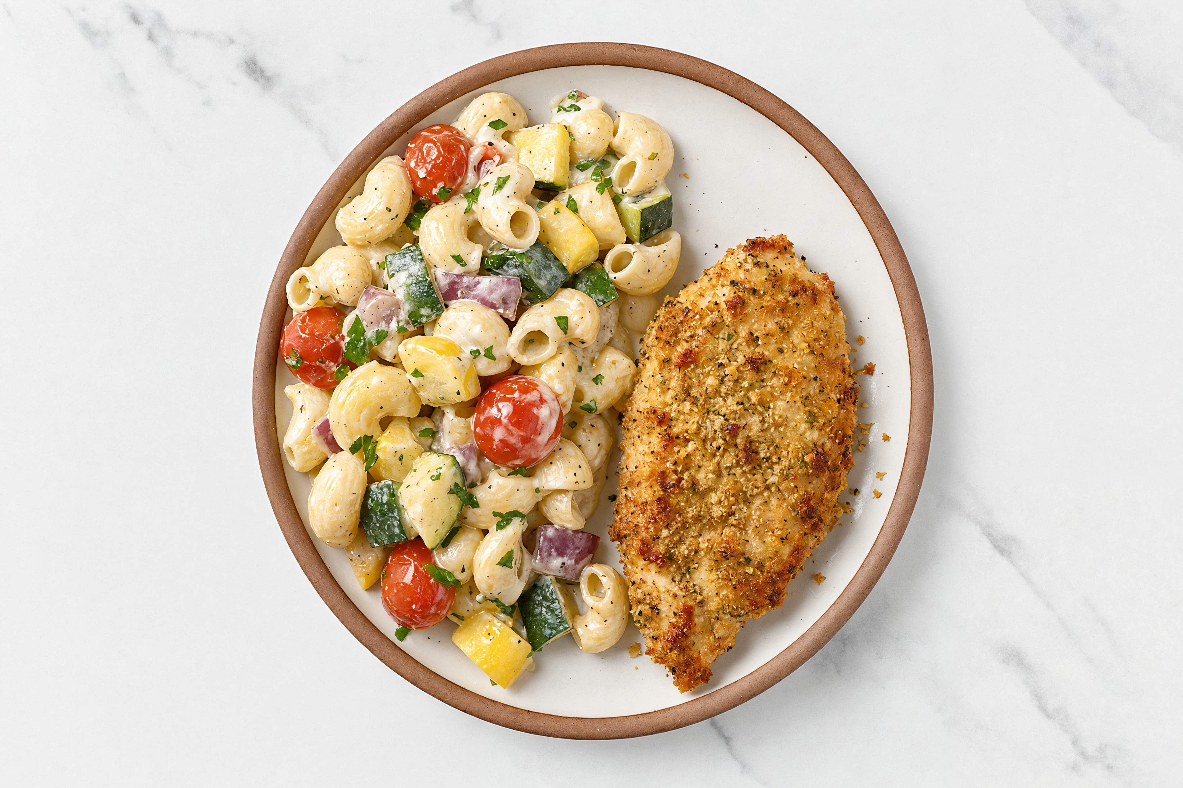 Crispy Garlic Chicken over Alfredo Chiocciole Pasta with Mixed Veggies
