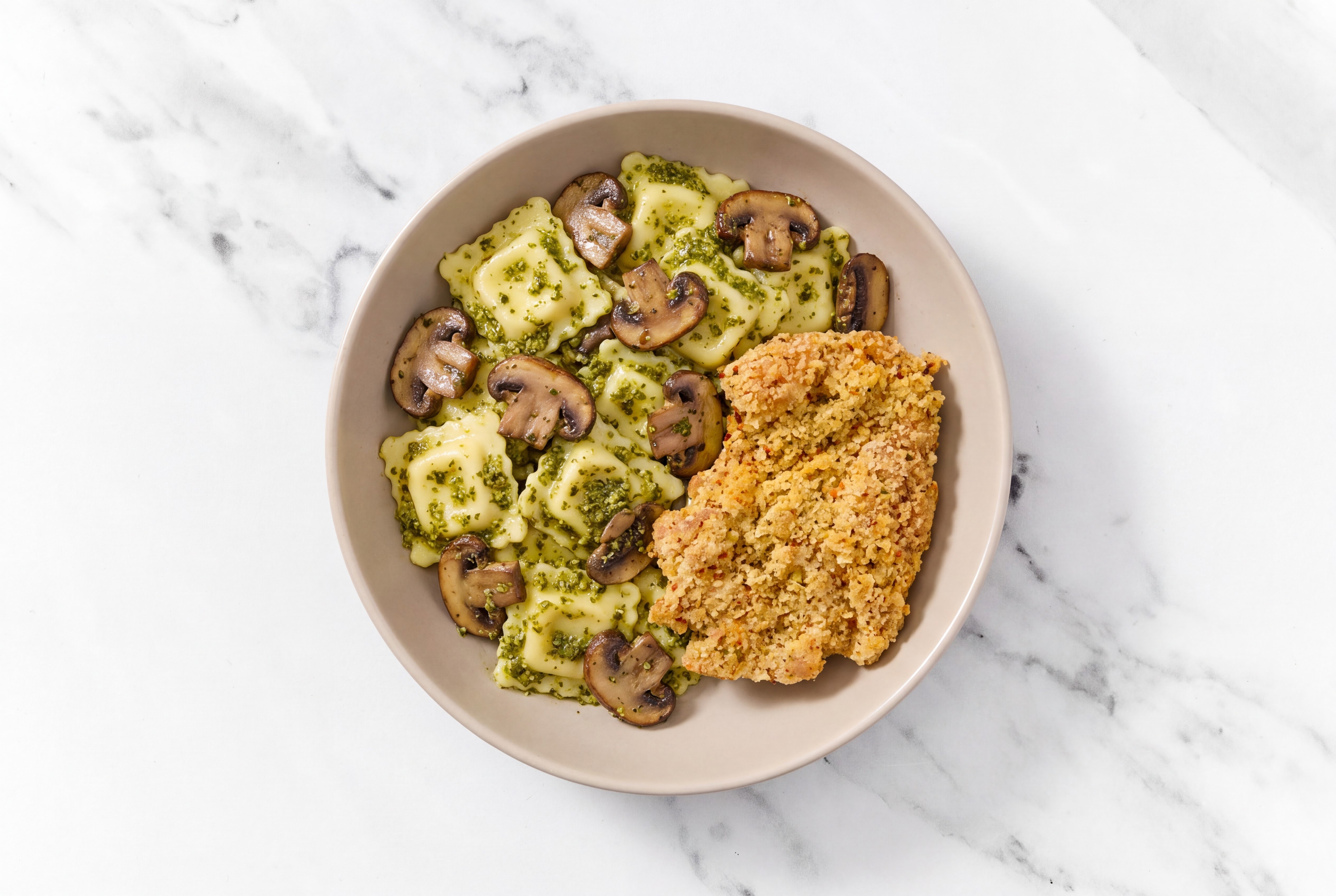 Crispy Garlic Chicken over Pesto Ravioli with Baby Bella Mushrooms