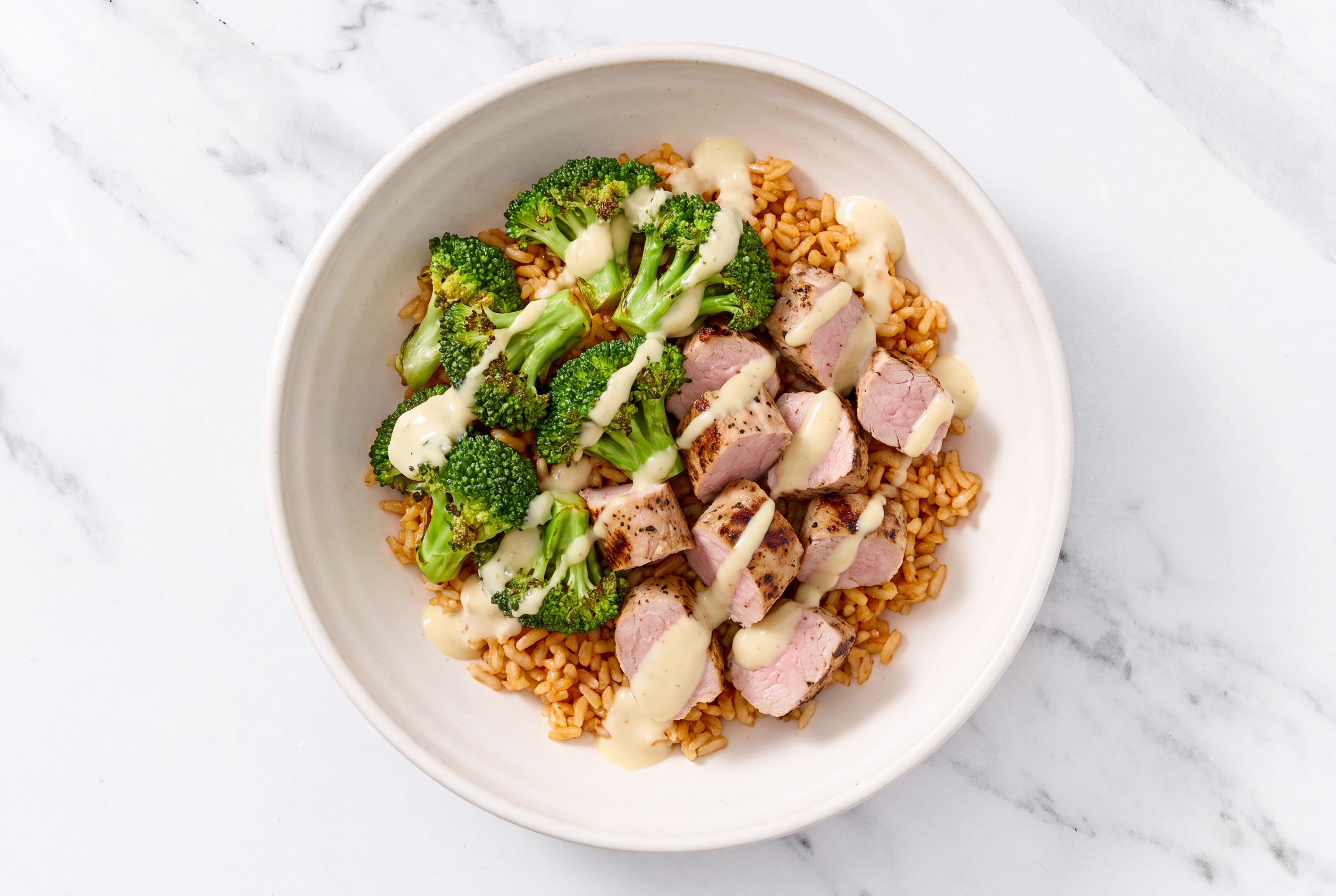Creamy Pork Tenderloin Brown Rice Bowl with Miso Caesar Dressing & Drizzle
