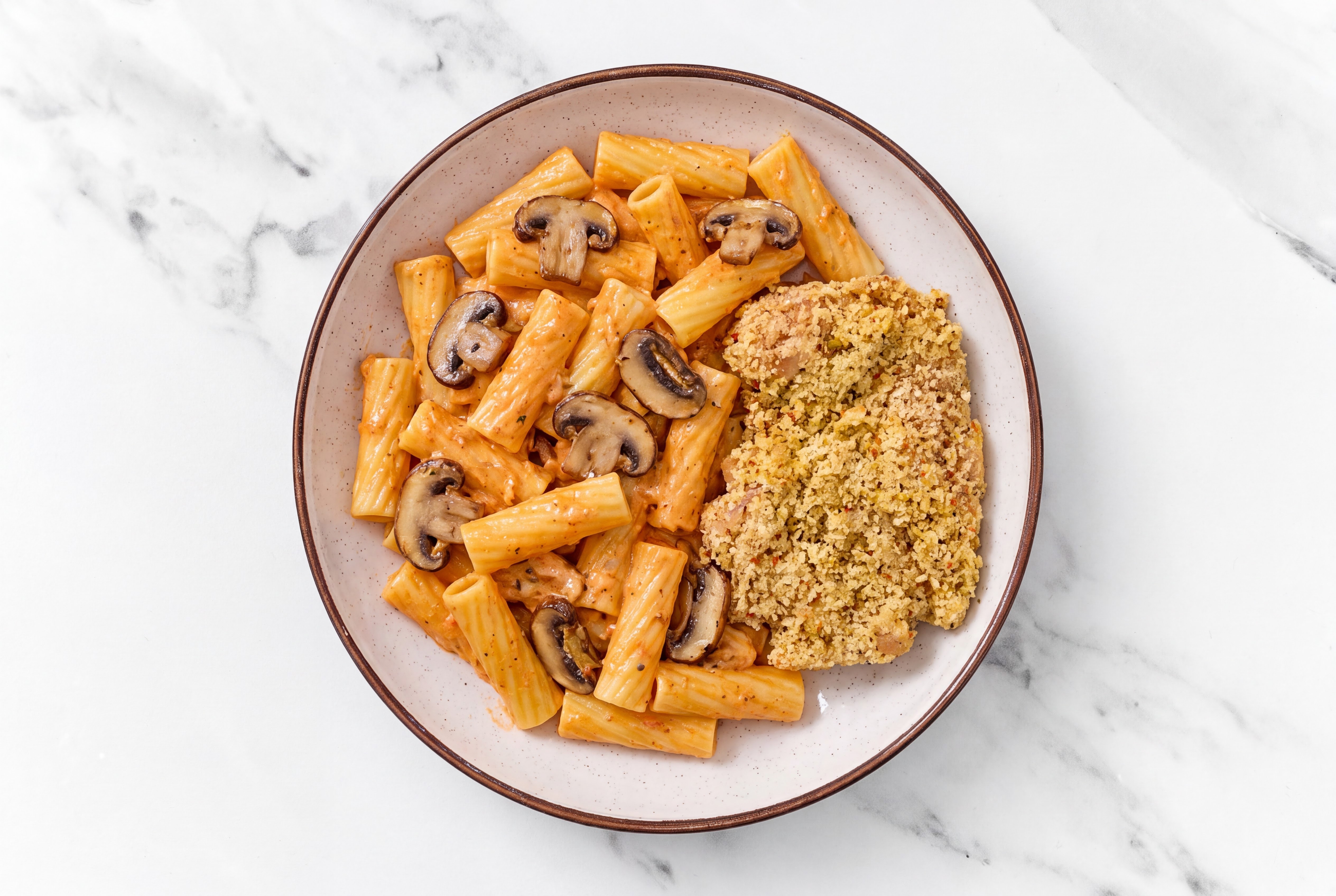 Crispy Garlic Chicken over Creamy Vodka Rigatoni with Baby Bella Mushrooms