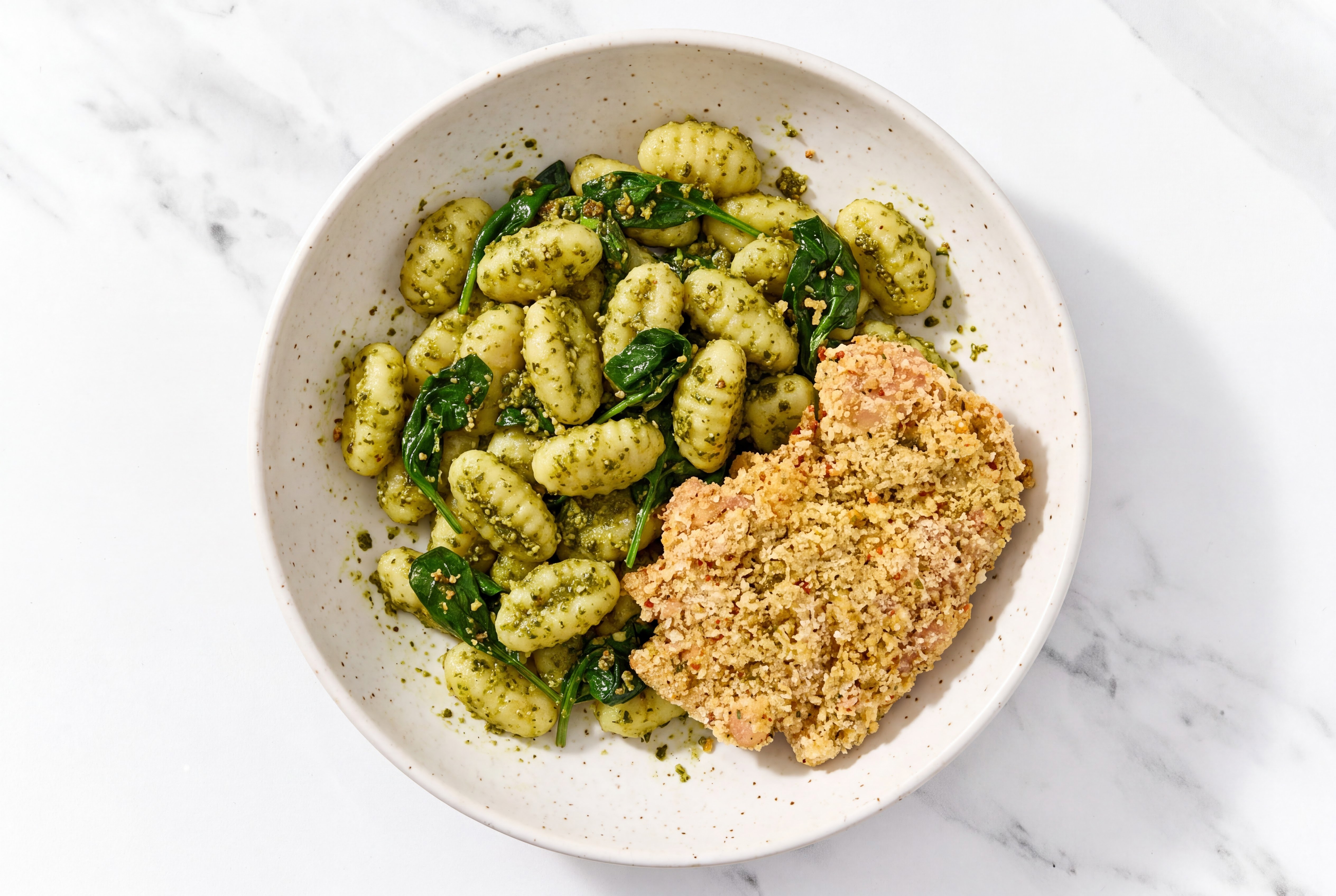 Crispy Garlic Chicken over Pesto Gnocchi with Baby Spinach