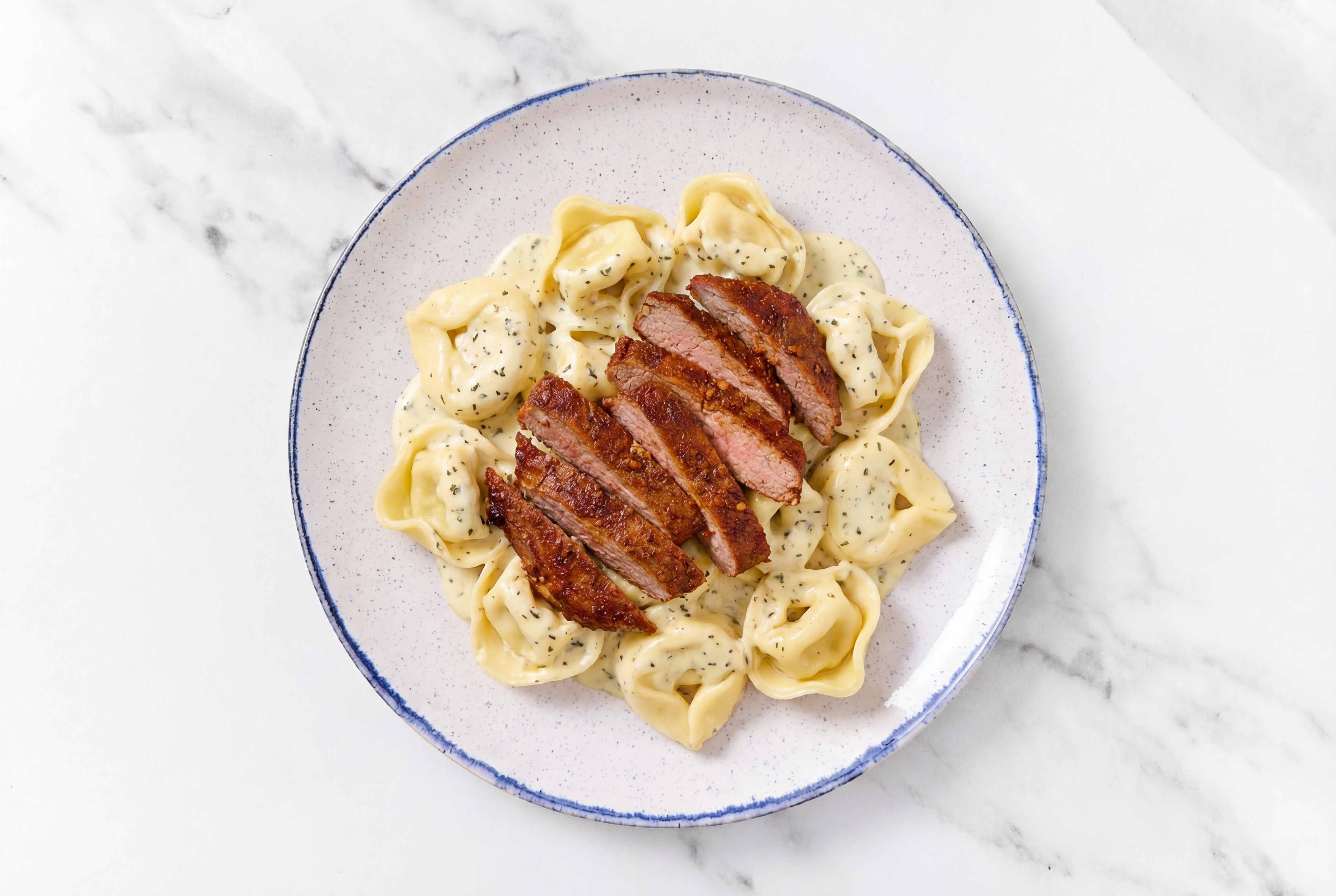 Steakhouse Tortelloni Herb Cream with Adobo Marinated Flank Steak