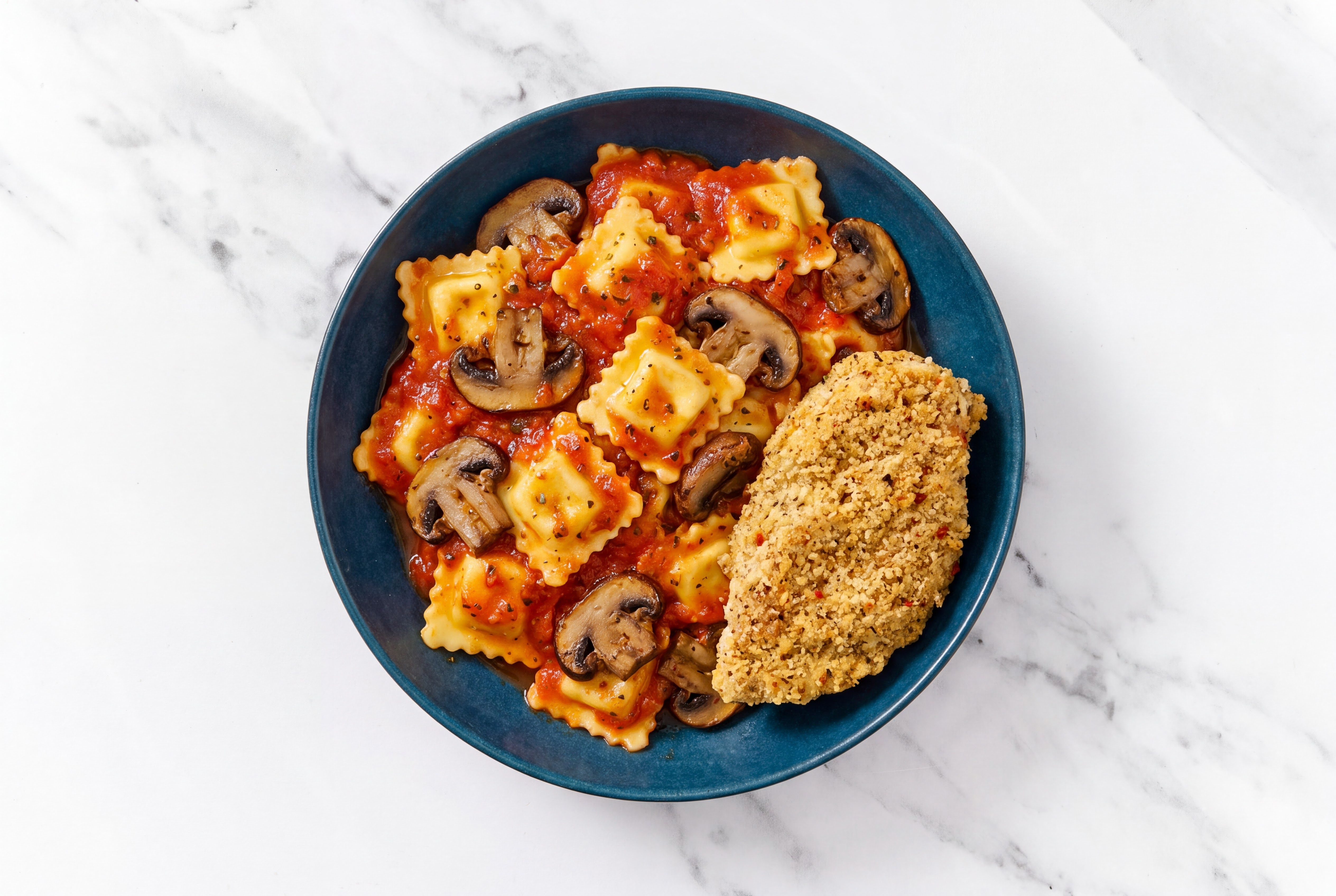 Crispy Garlic Chicken over Marinara Ravioli with Baby Bella Mushrooms