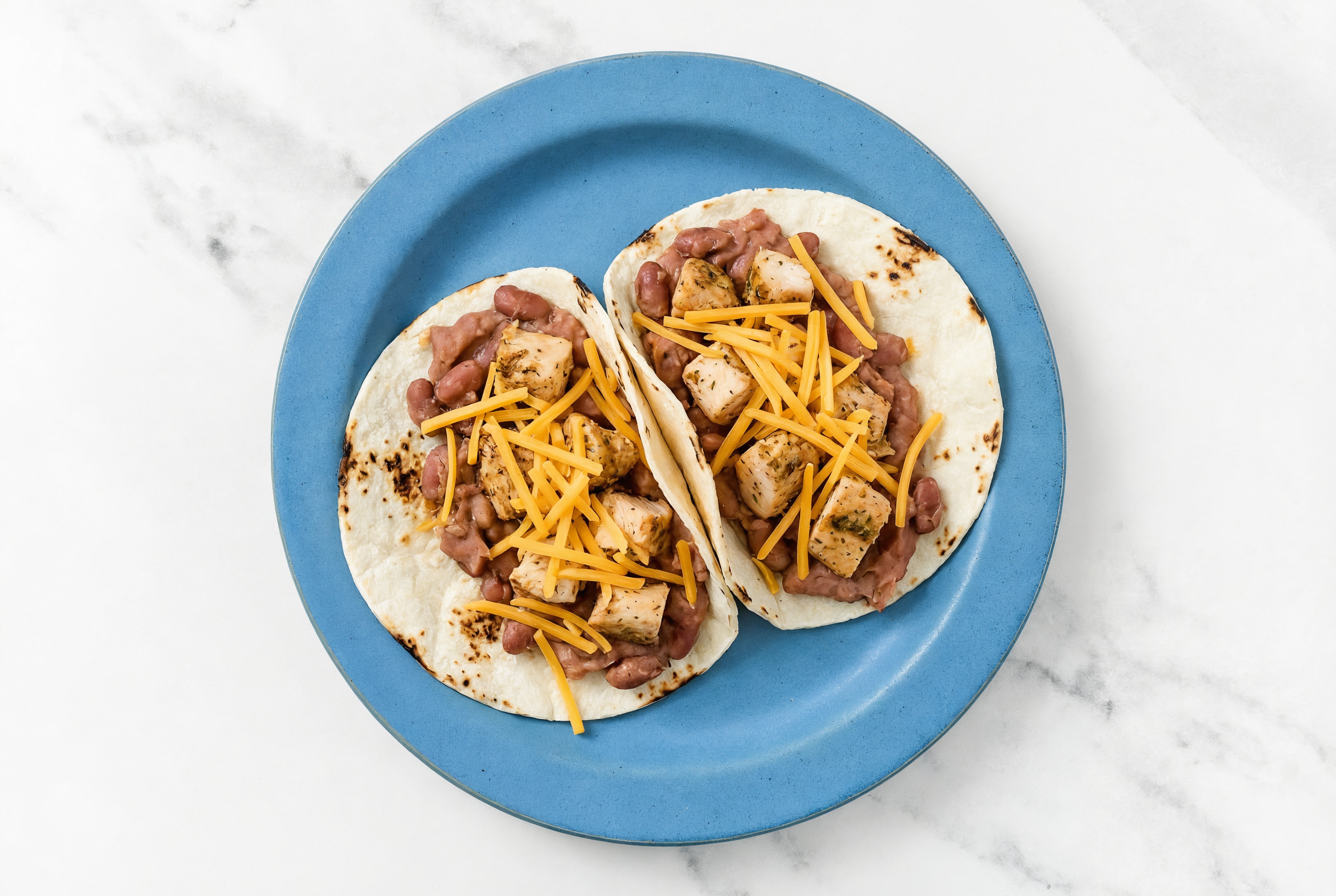 Hearty Garlic Chicken Tacos with Cheddar Cheese & Refried Red Beans