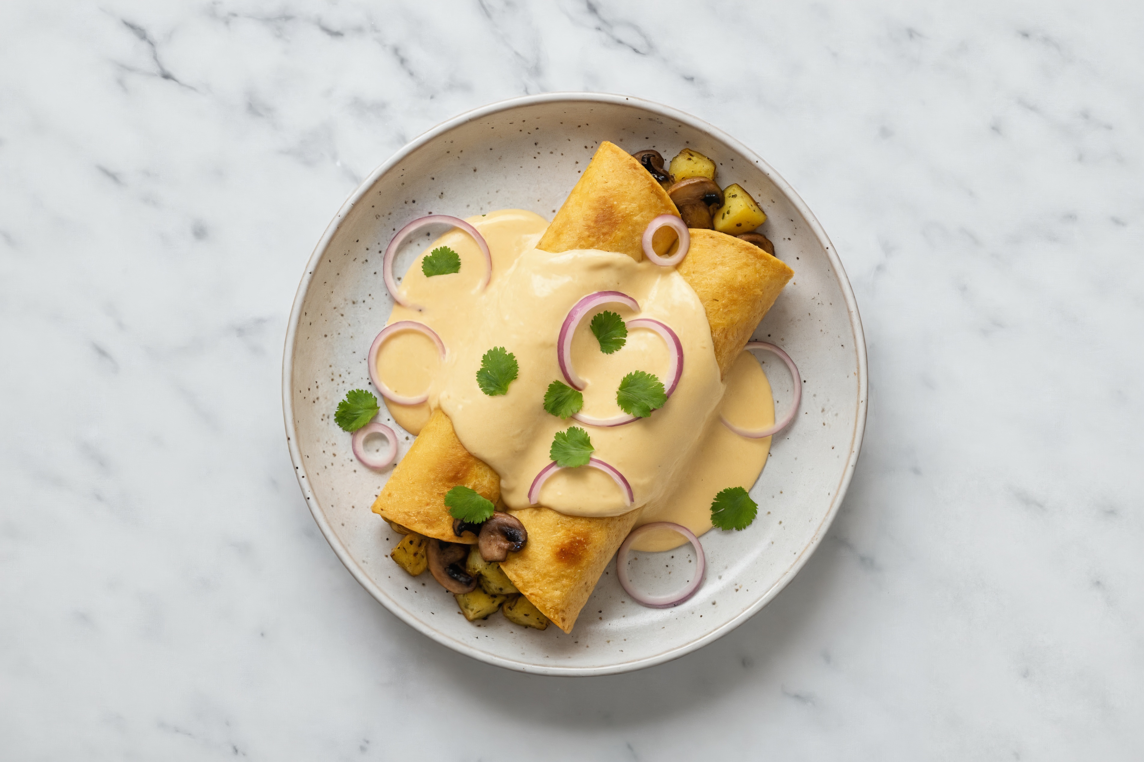 Vegan Herby Potato + Mushroom Enchiladas in Queso Sauce with Fresh Cilantro