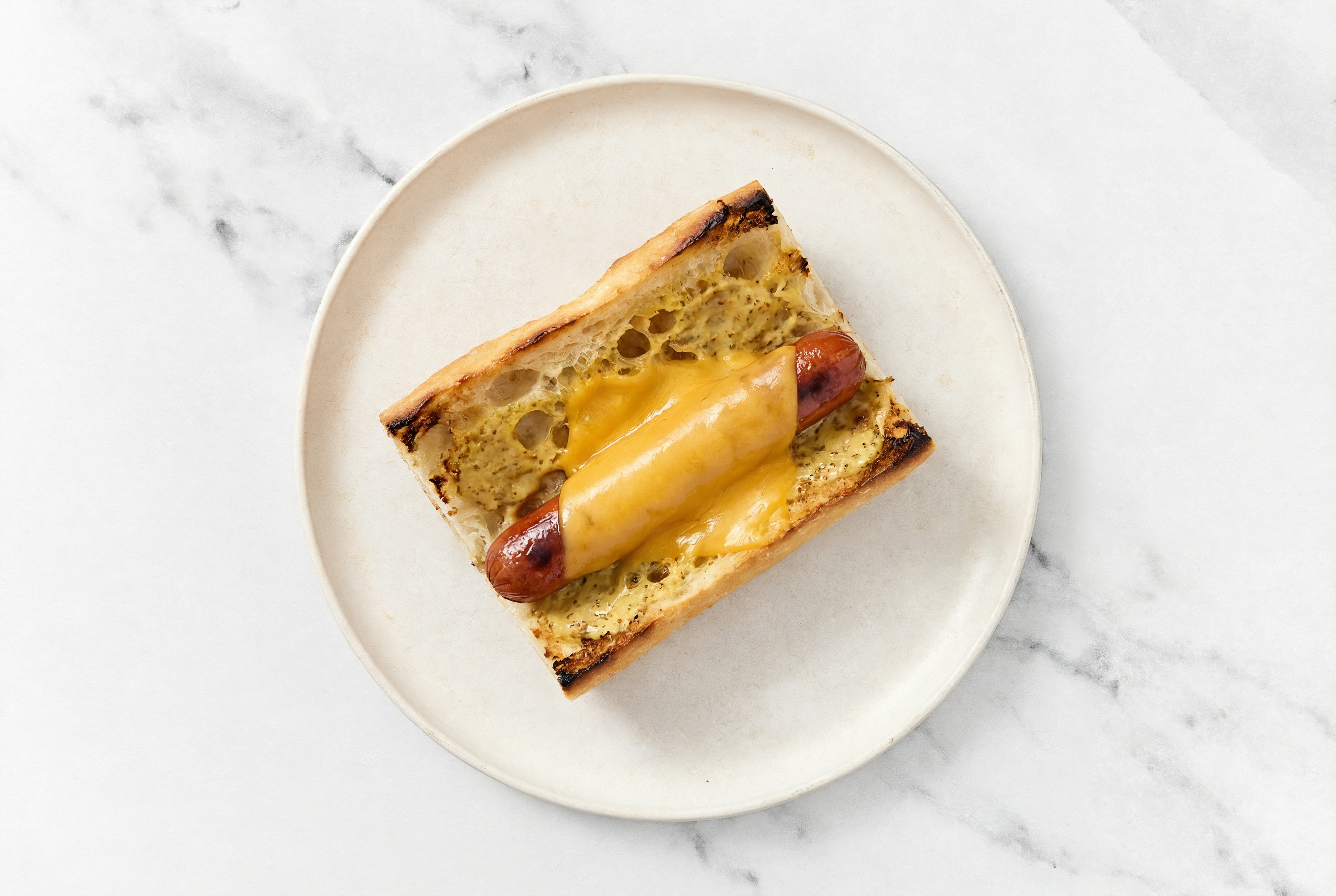Cheddar Beef Hot Dog with Honey Mustard on Baguette