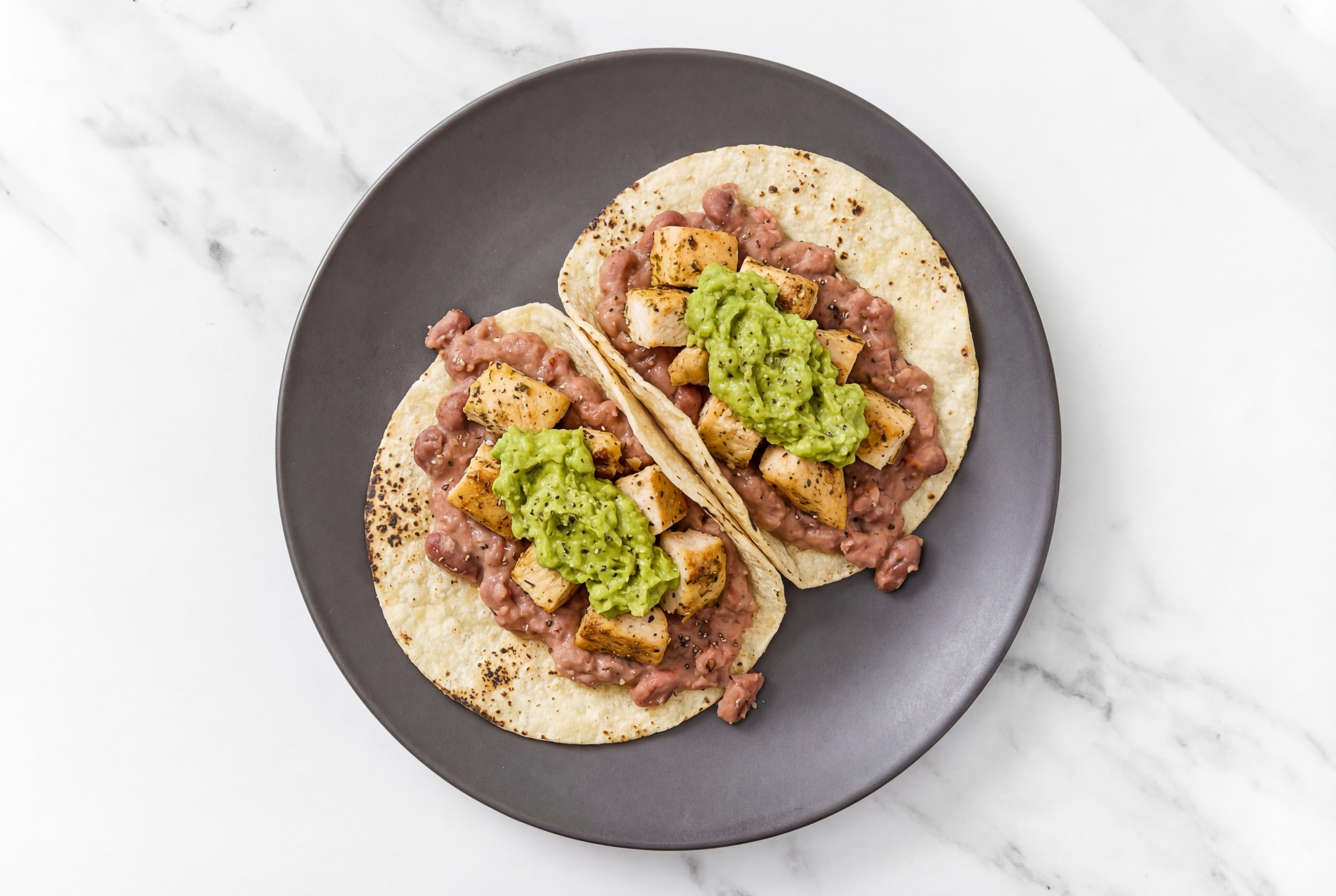 Hearty Garlic Chicken Tacos with Guacamole & Refried Red Beans