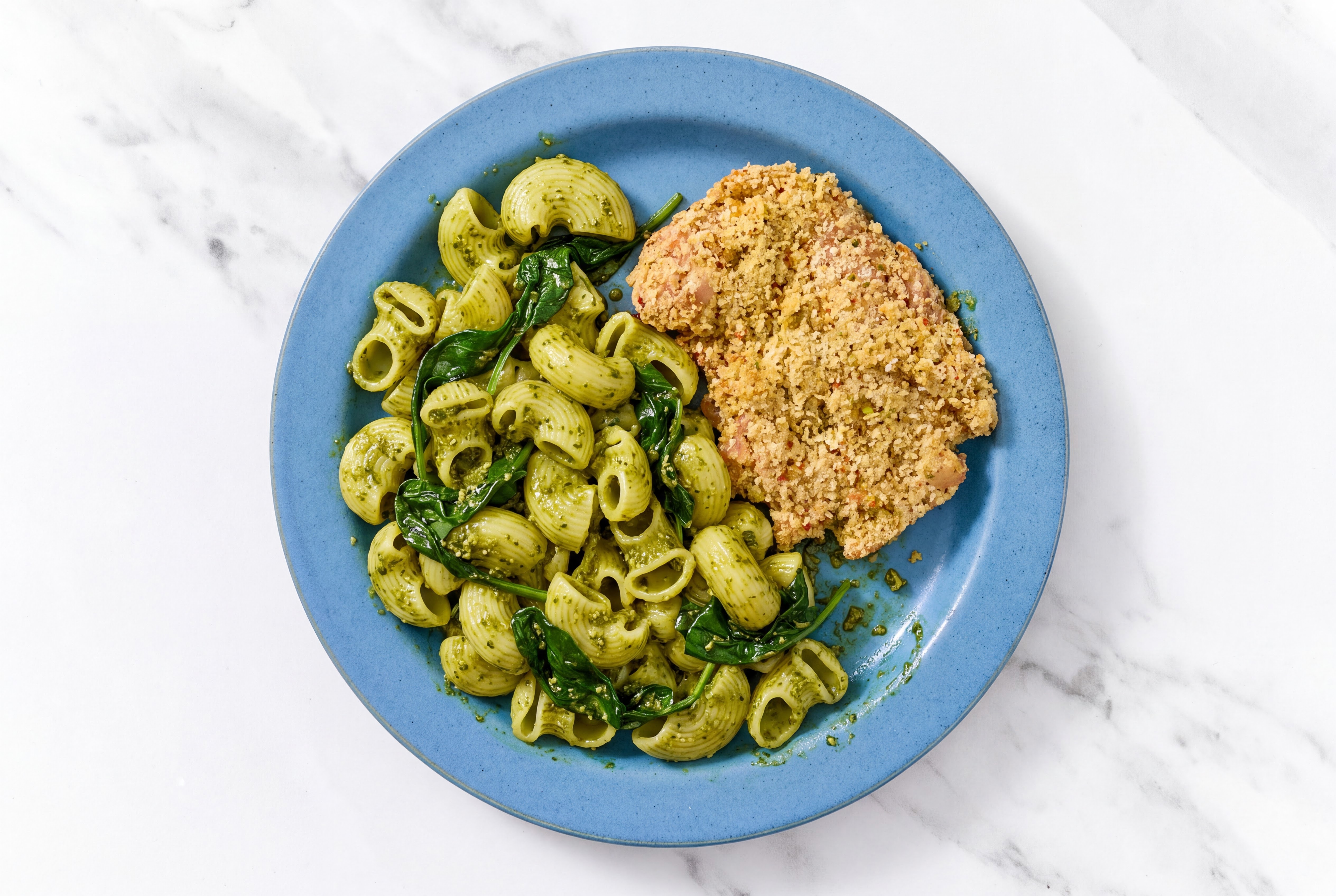 Crispy Garlic Chicken over Pesto Chiocciole Pasta with Baby Spinach