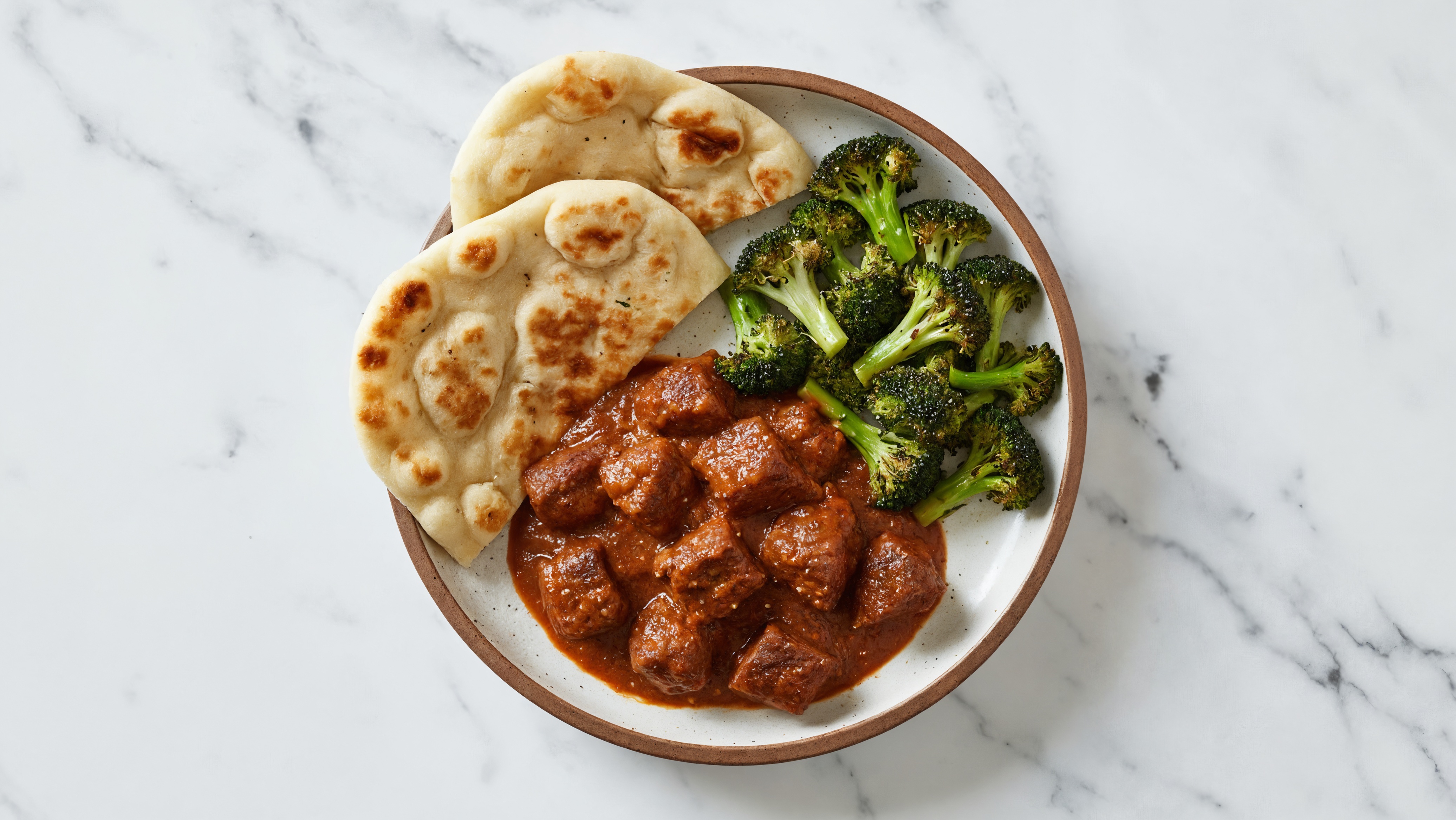 Herby Lamb Vindaloo + Naan with Broccoli Florets