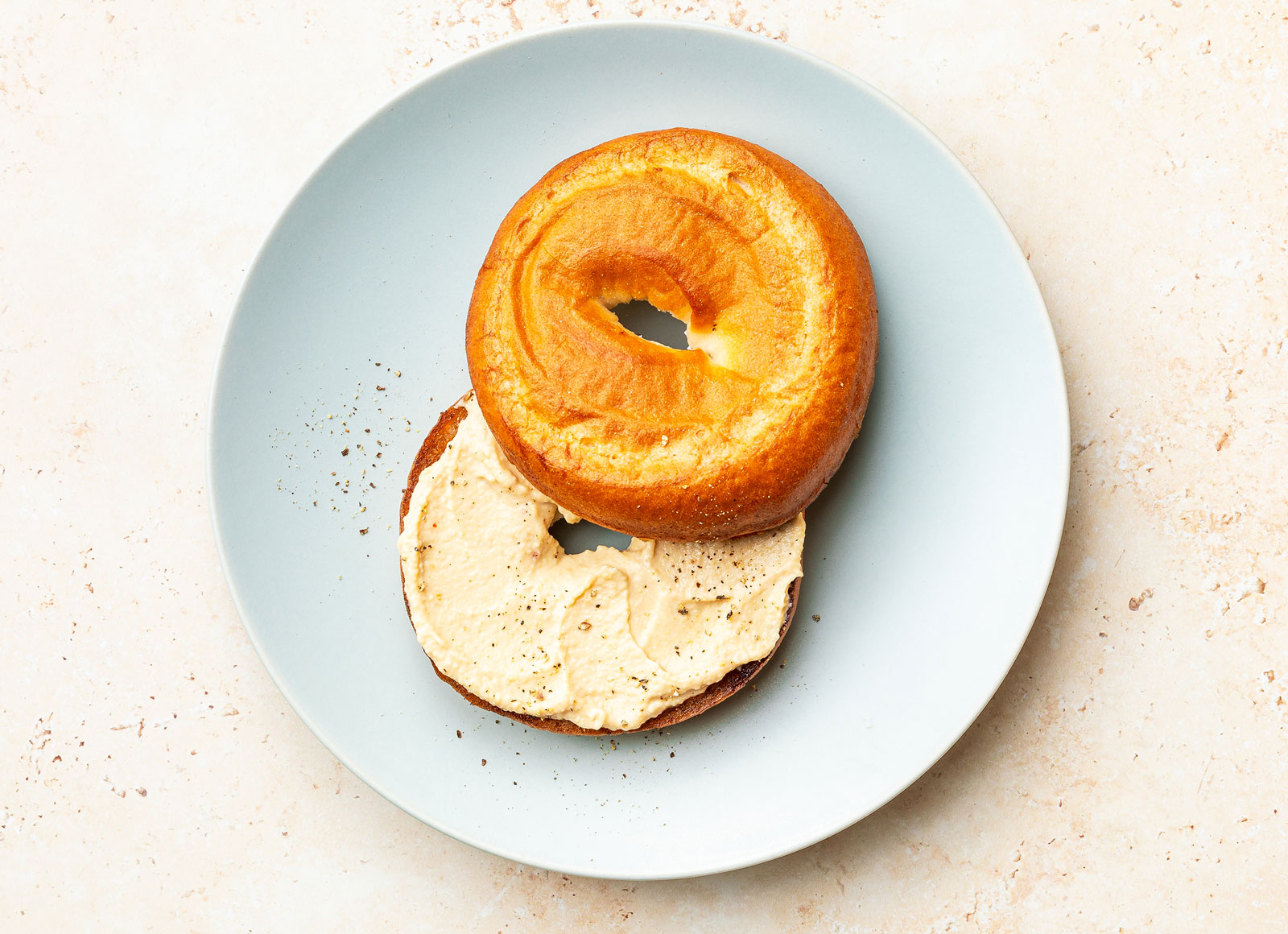 Lemon Garlic Hummus on a GF Bagel