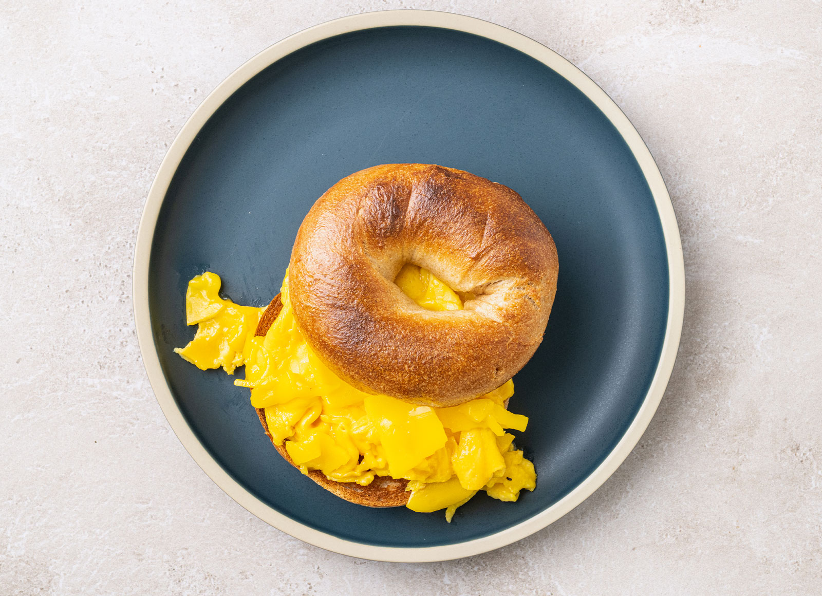 Cheddar Cheezy Breakfast Scramble Bagel