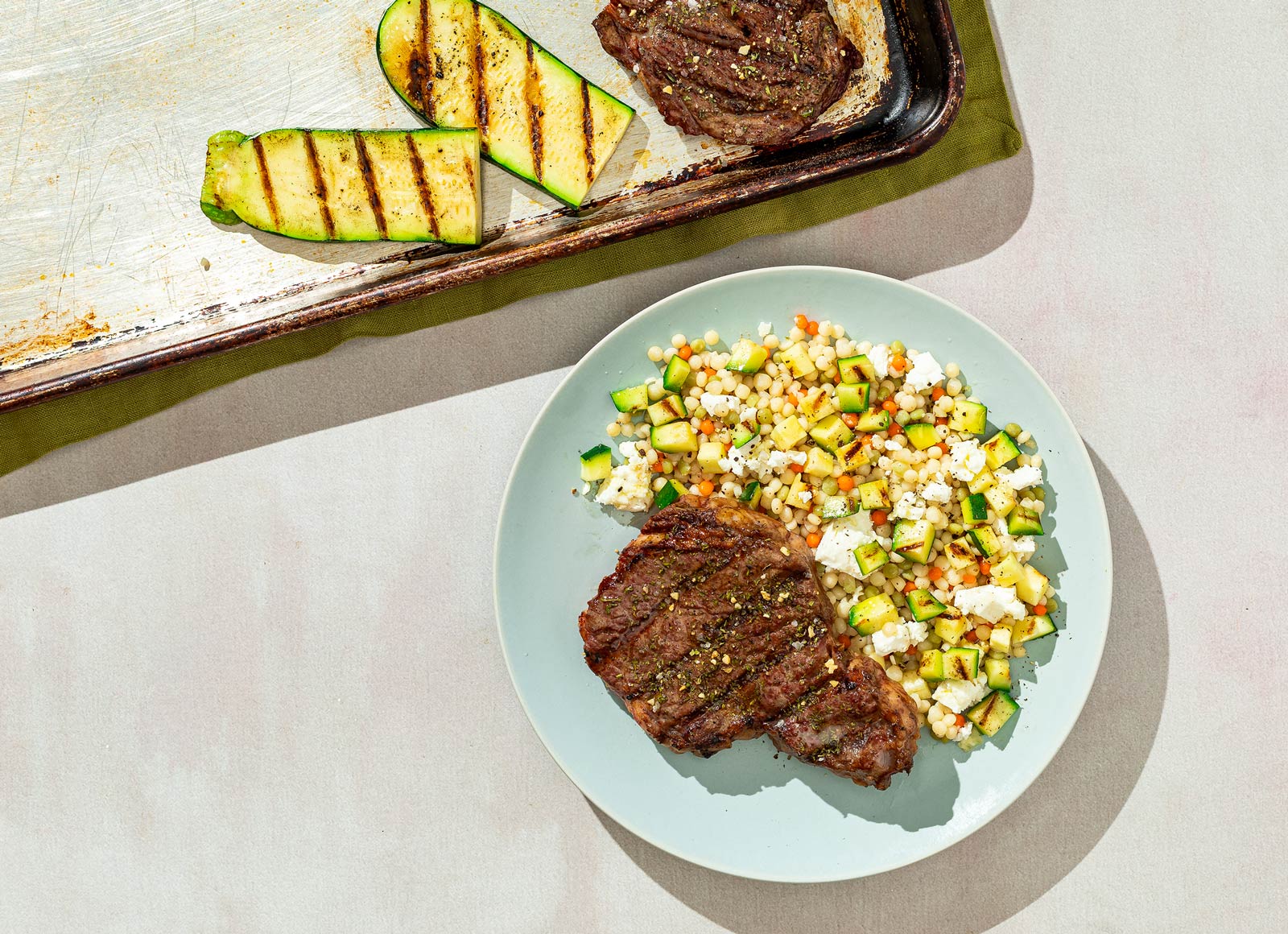 Balsamic Grilled Beef Ribeye Steak with Zucchini + Feta Tri-Color Pearled Couscous