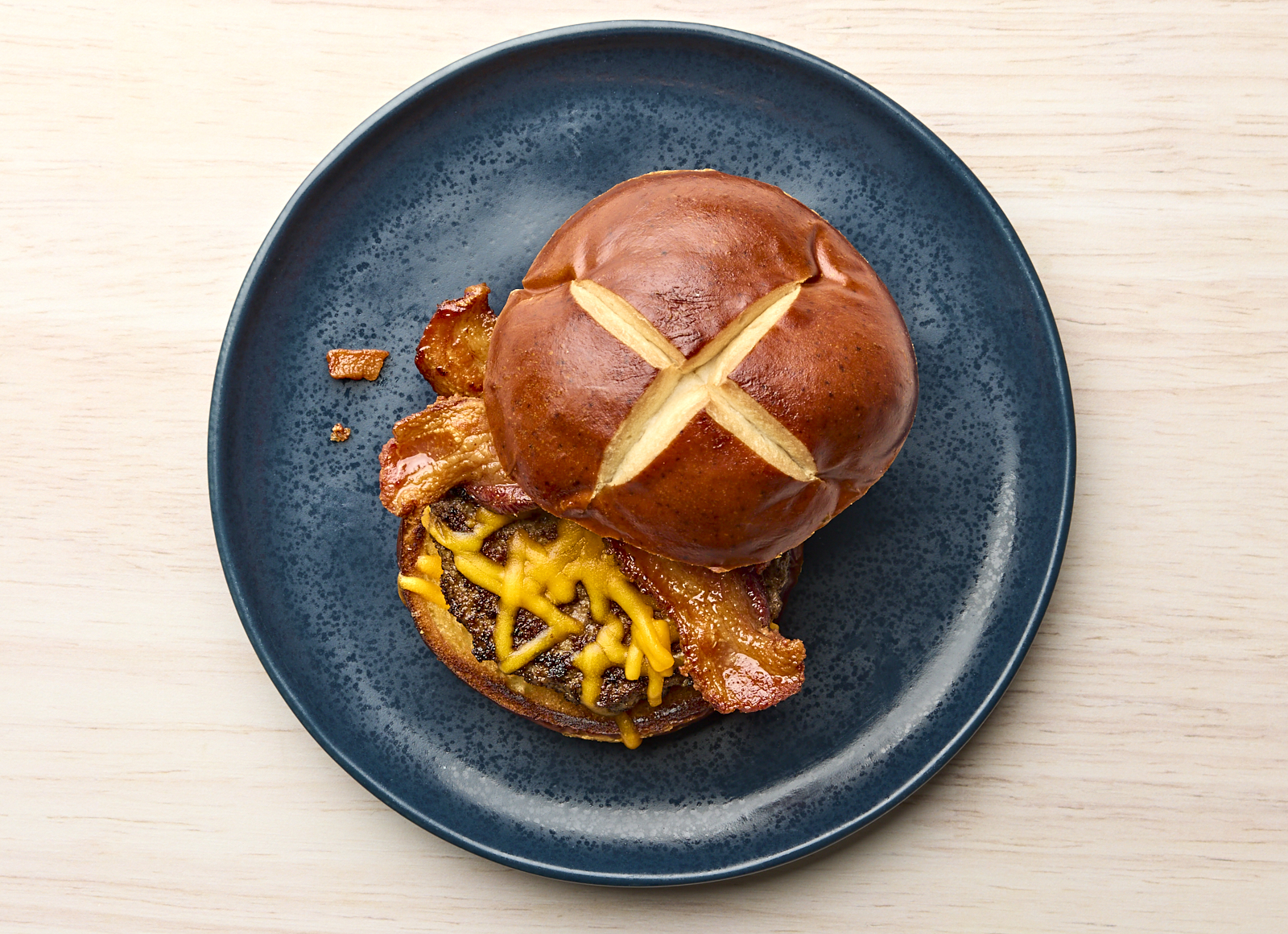 Juicy Applewood Smoked Pork Bacon Cheeseburger on Pretzel Bun